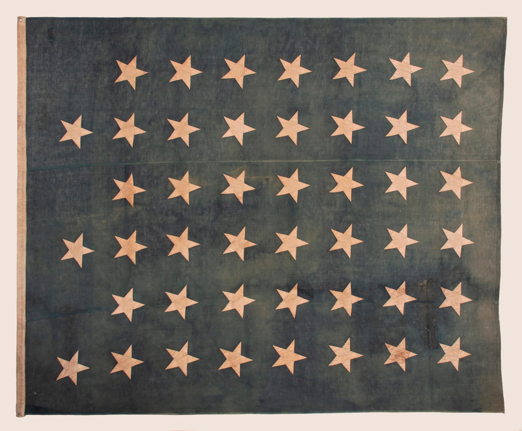 LARGE & BEAUTIFULLY FADED, ANTIQUE AMERICAN JACK w/ 45 STARS ARRANGED IN A “NOTCHED” PATTERN, INTENTIONALLY LEAVING SPACE FOR THE 3 REMAINING WESTERN TERRITORIES YET TO BE ADDED; MADE IN THE PERIOD BETWEEN 1896 - 1908, WHEN UTAH WAS THE MOST RECENT