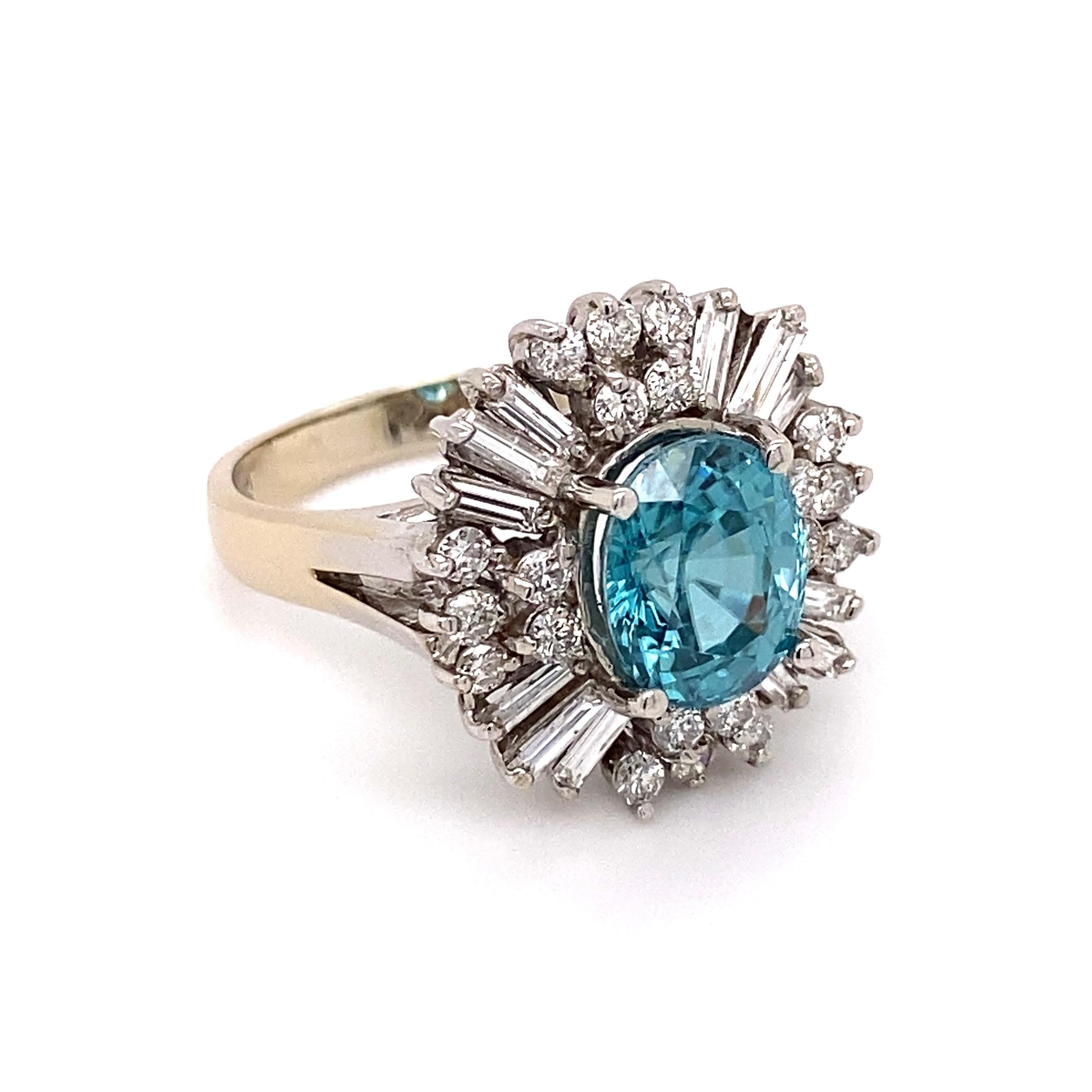 Simply Beautiful! Finely detailed Gold Ballerina Ring, center securely nestled with an oval Blue Zircon, weighing approx. 4.50 Carats surrounded by baguette and round Diamonds; approx. total weight of Diamonds 1.28 Carats. Approx. dimensions: 1.19”