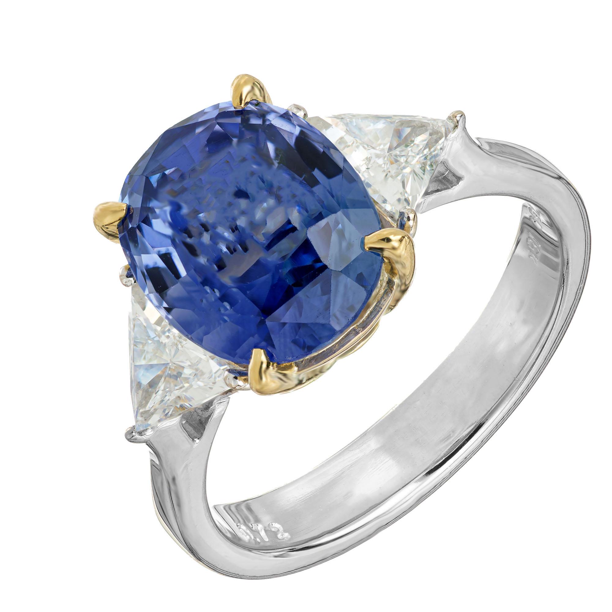 Sapphire and diamond engagement ring. 4.50ct oval AGL certified center cornflower sapphire, accented with tow trilliant cut side diamonds in a three-stone 18k yellow and white gold setting. AGL certified  natural simple heat only. 

1  medium