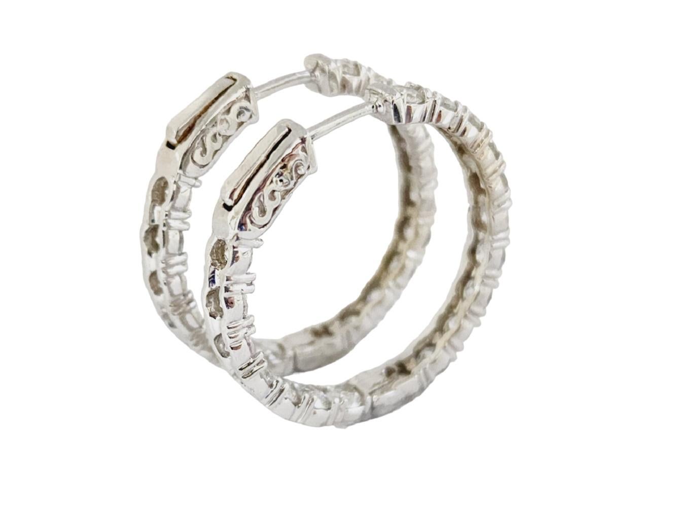 Beautiful pair of natural diamond inside out hoop earrings in 14K white gold. Secures with snap closure for wear. Average Color H, Clarity I, Measures 1 inch x 1 inch diameter. 