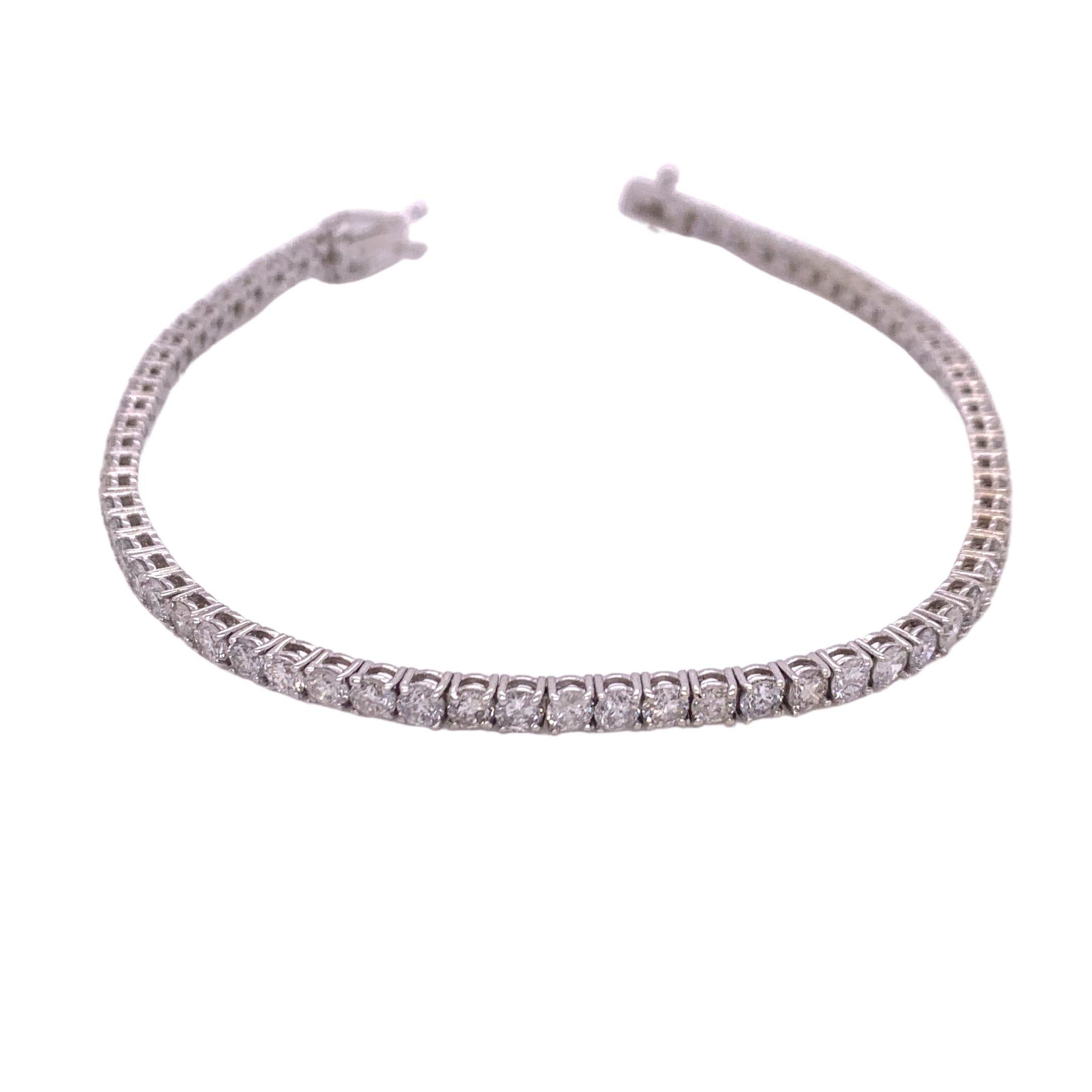Diamond tennis/line bracelet made with real/natural brilliant cut diamonds. Diamond Weight: 4.56 carats, Diamond Quantity: 67 (round diamonds). Mounted on 18 karat white gold.