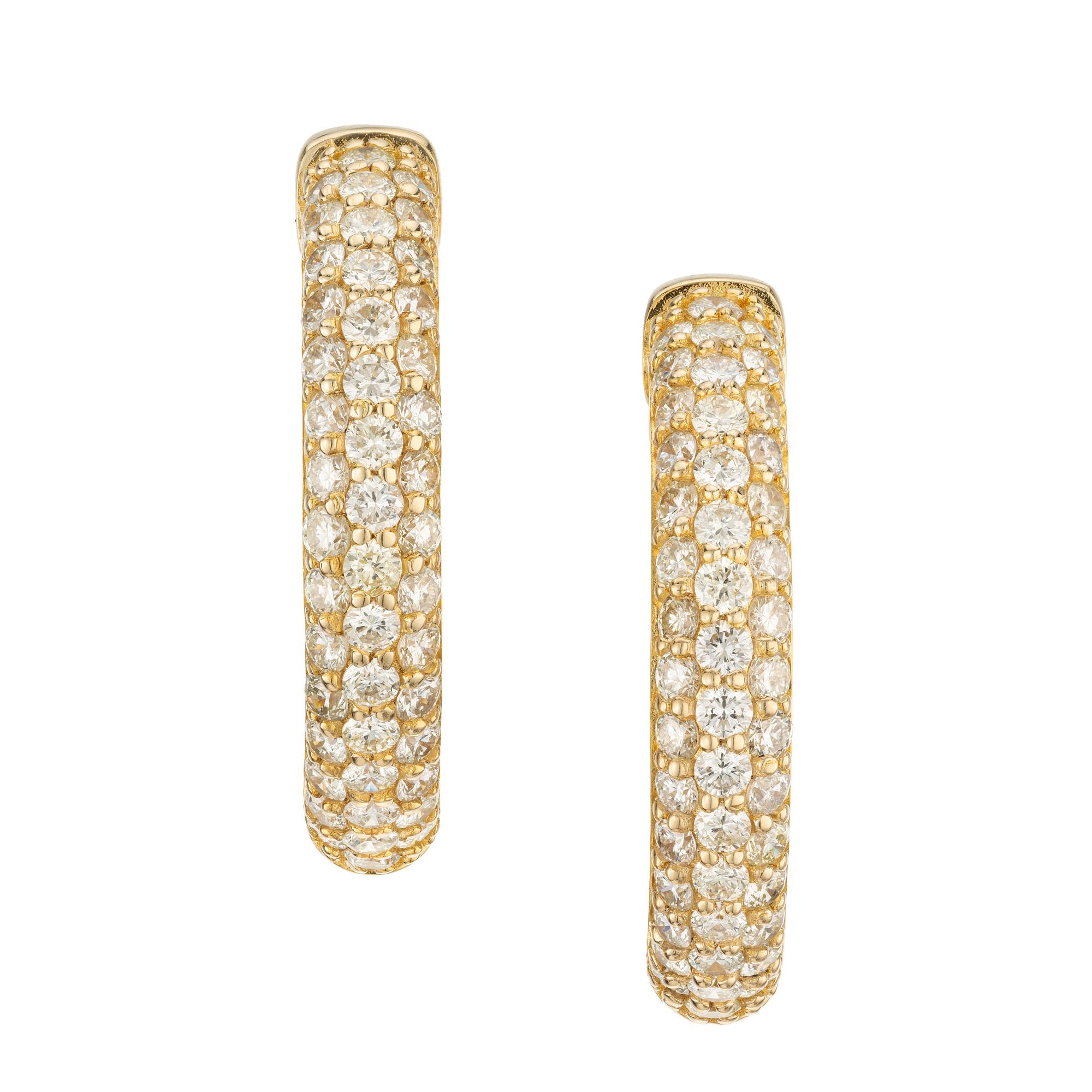 Indulge in the opulent allure of our 4.50 carat three row diamond yellow gold hoop earrings, a true masterpiece of elegance and sophistication. These earring have an 1.11 Inch diameter hoop with a post and safety lock. These hoops are meticulously