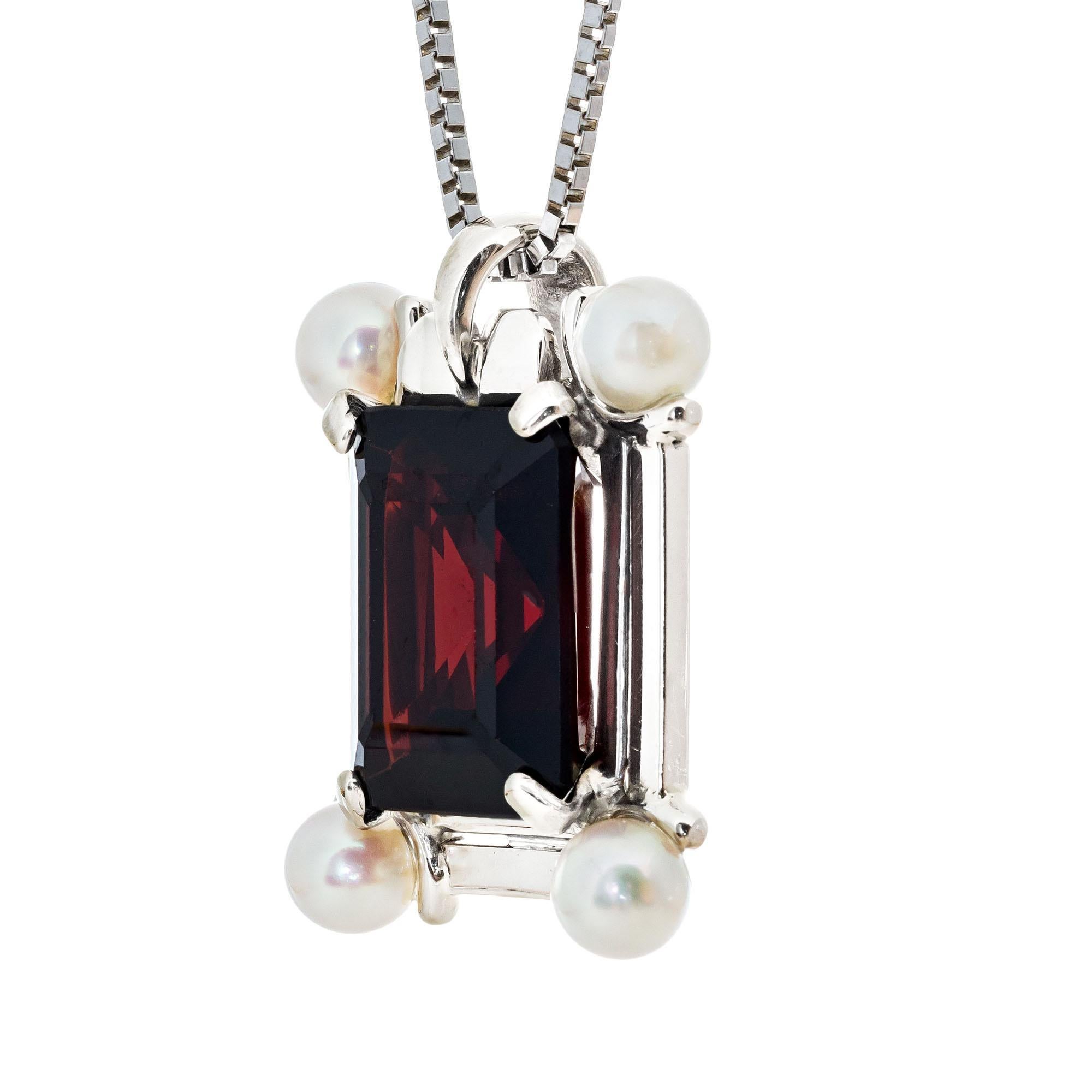 1950's Mid Century pendant necklace with a 4.50 carat Emerald cut center garnet with four cultured accent pearls in 14k white gold. 18.75 inches in length. 

1 rectangular brownish red garnet, approx. 4.50cts
4 cultured white pearls 
14k white gold