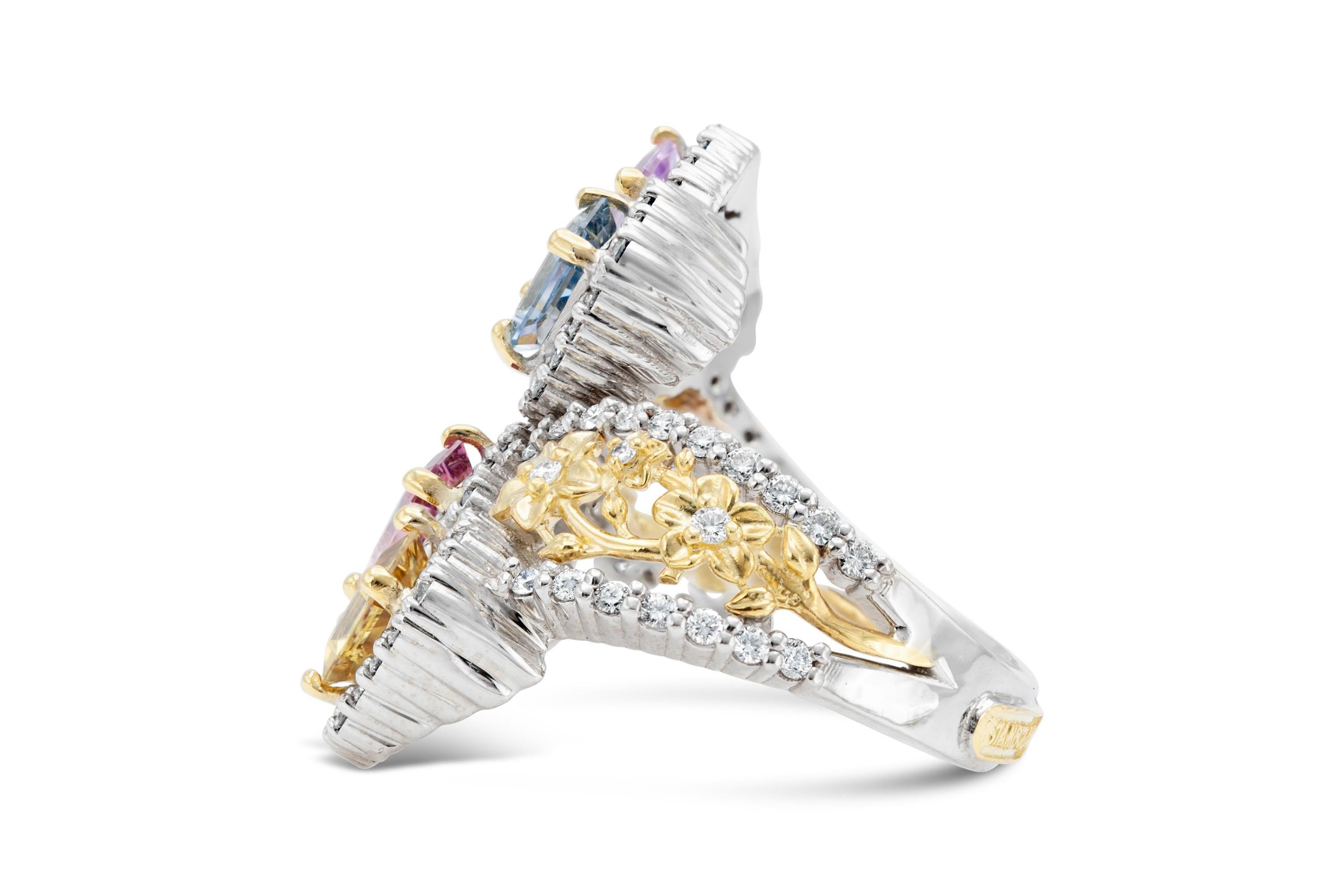 Finely crafted in 18k white and yellow gold with four Emerald cut non-heat treated multi-color Sapphires weighing a total of 4.50 carats and accenting Round Brilliant cut Diamonds weighing a total of 1.20 carats. 
G color, VS1-VS2 clarity
Signed by