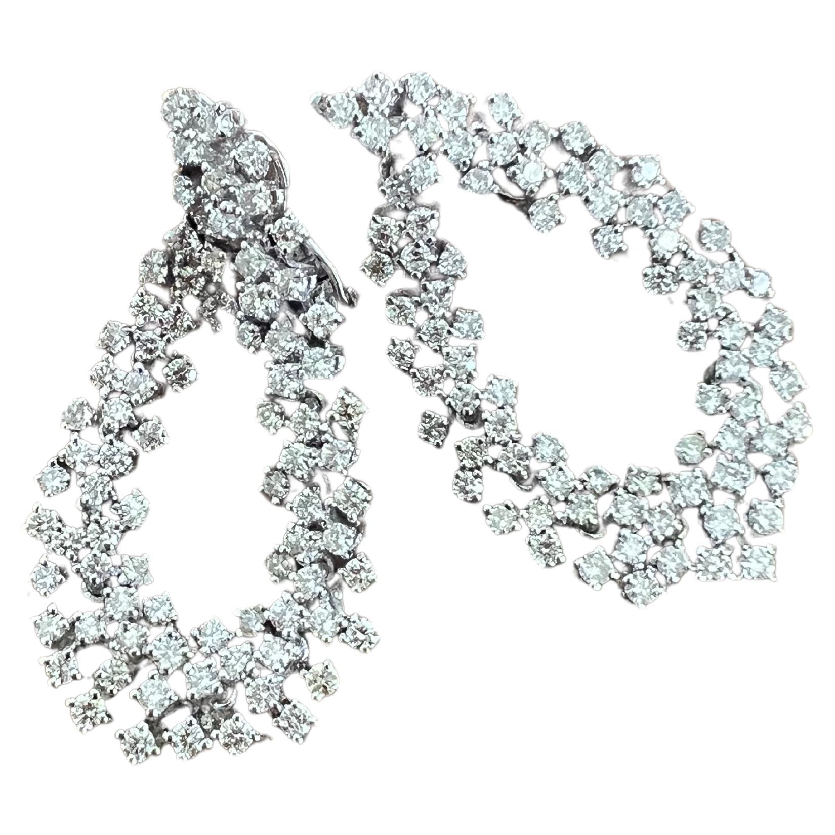 These earrings have Natural Round Cut White Diamonds that weigh 4.50 carats. The clarity and color of the earrings are VS-H. 

They are 1.5 inches long and are curated in 14 Karat White Gold with an approximate weight of 14.5 grams. 

Stunning