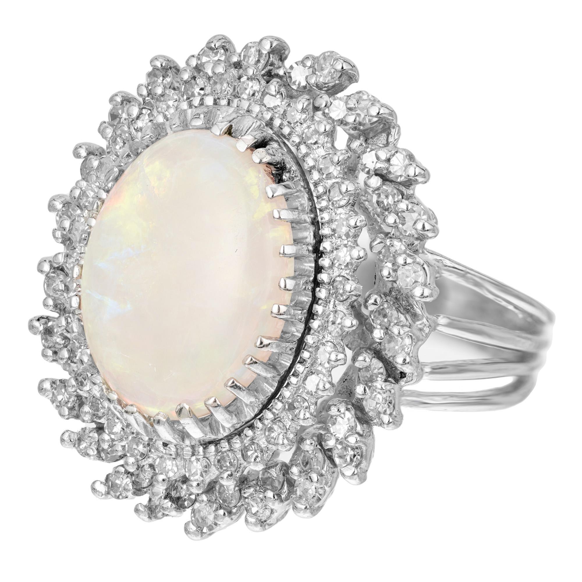 1950s large opal and diamond 14k white gold dinner style cocktail ring. Set with 4.50ct oval well-polished Opal with great color flash. Surrounded by a double halo of 84 full cut diamonds. On row consists of double diamonds, essentially making it a