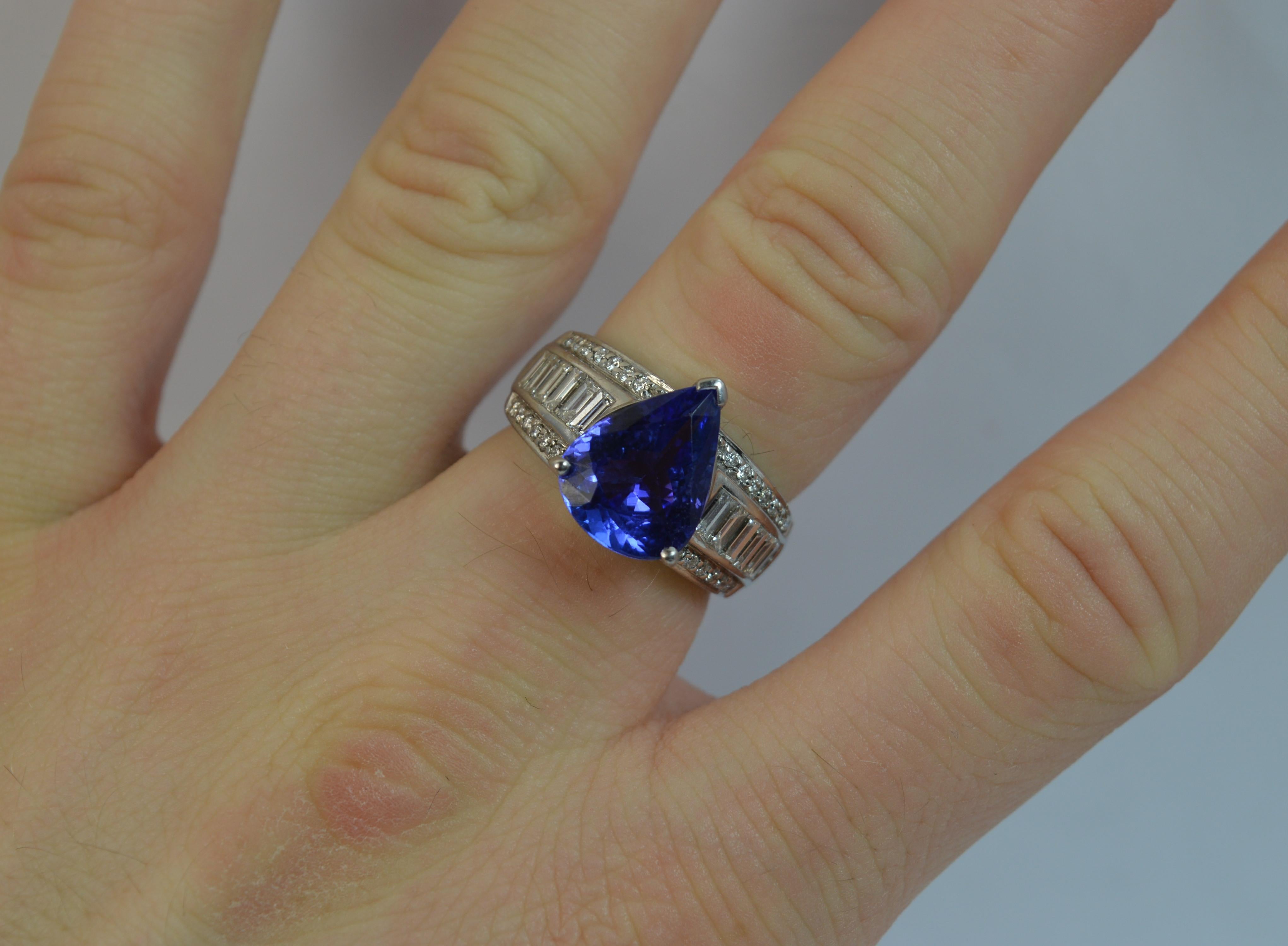 
A superb ladies Tanzanite and Diamond ring.

Solid 18 carat white gold shank and setting.

​Designed with a natural pear cut Tanzanite to the centre in a three claw setting. 10mm x 13mm approx, 4.50 carats. Beautiful colour.

To each side are three