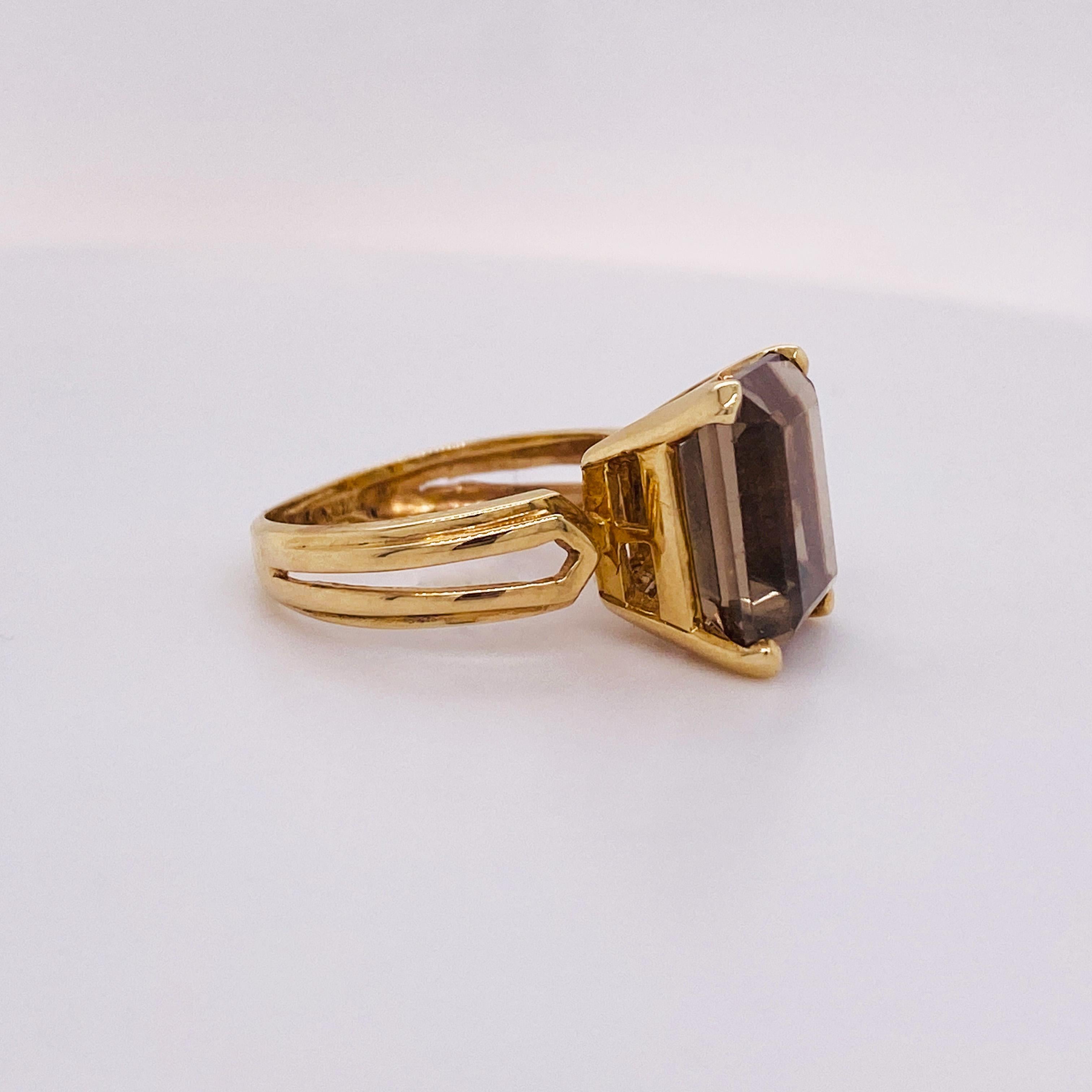 This Smokey Quartz Ring is very unique with the emerald cut 4.50 carat gemstone. The band of the ring is very special with a split and double bevel. The ring is solid 14 karat yellow gold and currently a size 5.5 but it is sizable. Your local