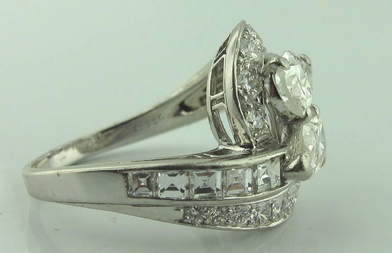 Cross Over Diamond ring featuring 2 center Pear shaped Diamonds in the center, weighing 1.56 carats, plus 10 French cut diamonds, weighing 1.00 carats, and 18 Round Brilliant Cut diamonds, weighing 0.85 carats,  30 Diamonds with a total  weight of