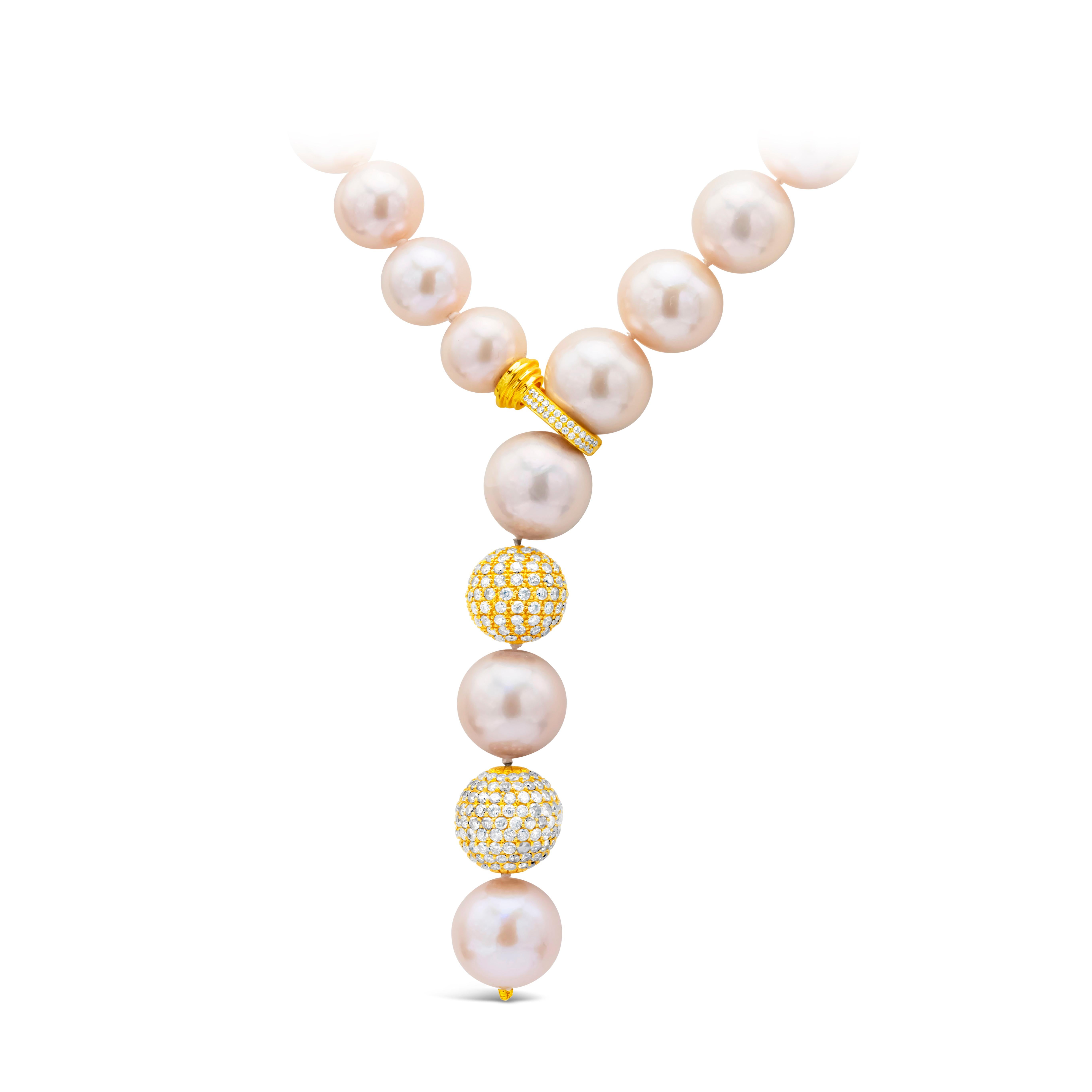 A beautiful pearl necklace showcasing 11.5-14.5mm south sea pink pearl with diamond clasp, and features 2 diamond encrusted balls. Diamond weigh 4.50 carats total. Made in 18K Yellow Gold.

Style available with matching earrings.