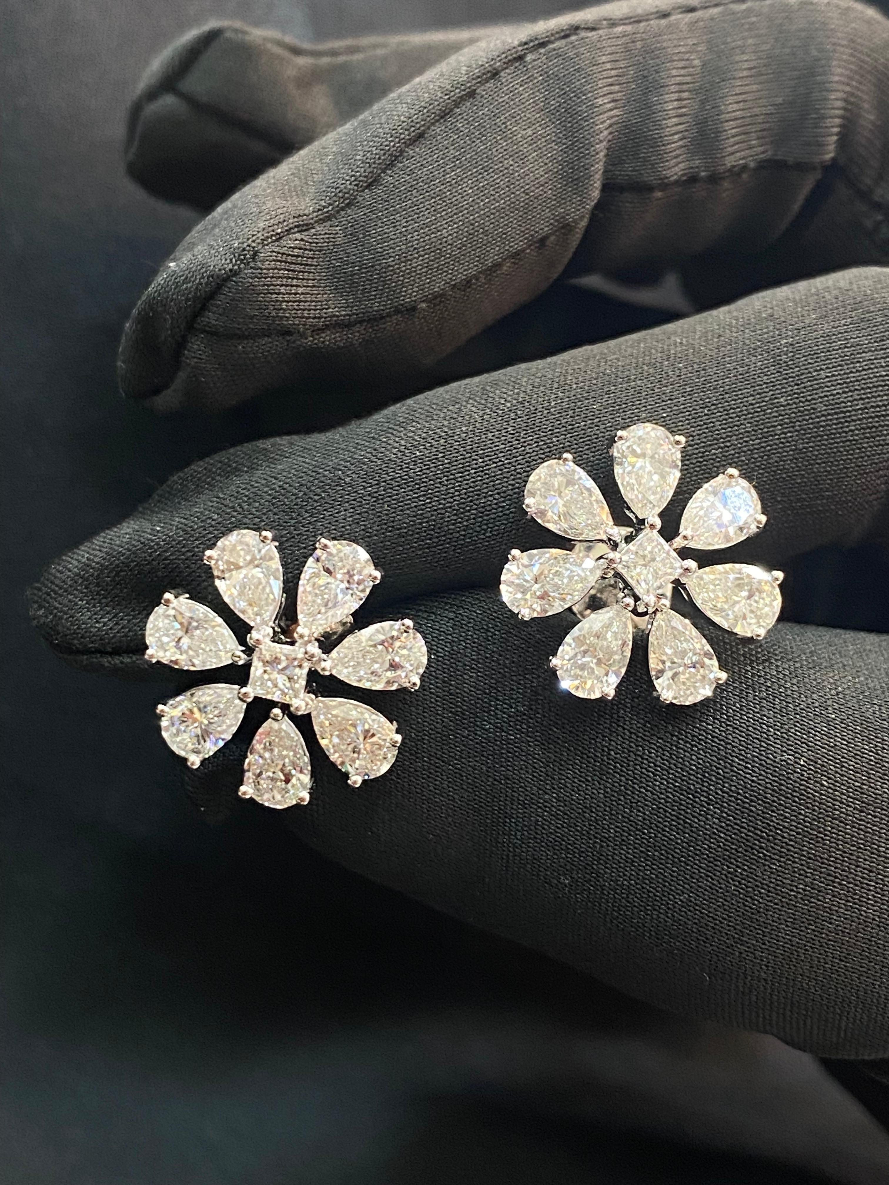 This elegant stud earrings feature a remarkable 4.50 carats of pear princess natural diamonds, set within a beautiful big flower design crafted from 14K white gold!

Specifications : 

Diamond Weight : 4.50 Cts [4.20 Cts Pear + 0.30 Cts