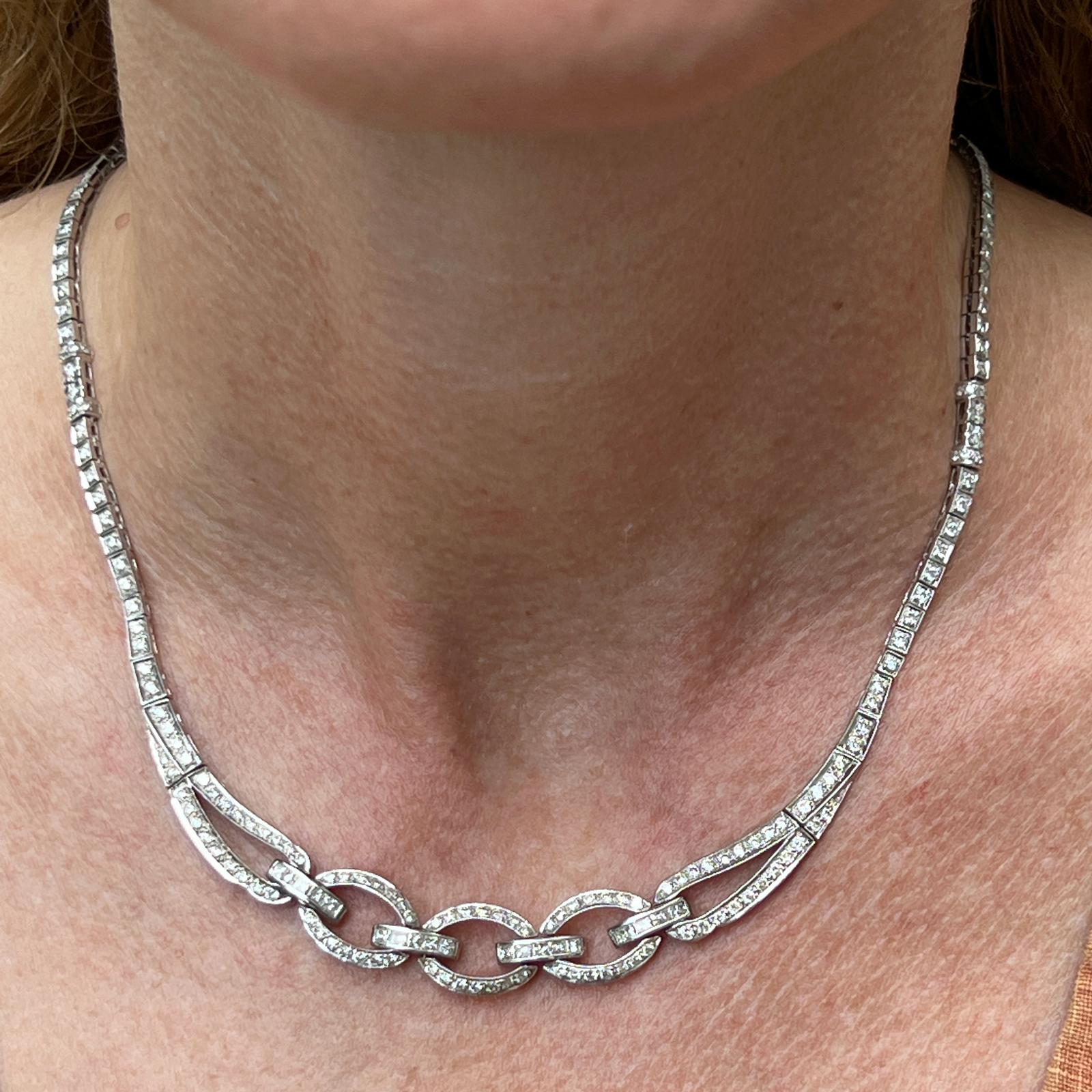 Glamorous diamond necklace fashioned in 18 karat white gold. The necklace features round brilliant and princess cut diamonds weighing approximately 4.50 carat total weight. The diamonds are graded H-I color and VS2-SI1 clarity. The necklace measures