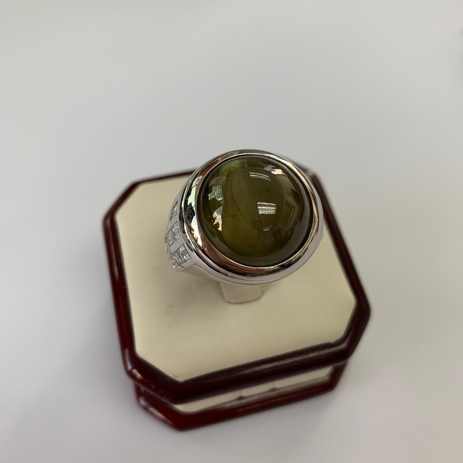 Natural Cat's eye Chrysoberyl gemstone certified by EGL USA. Top Gem Cats Eye with Cocktail Ring 18k white gold, total weight 48.85 carats. Side diamond total weight 1.43cttw. Total gram weight of the ring is 35.34 grams.