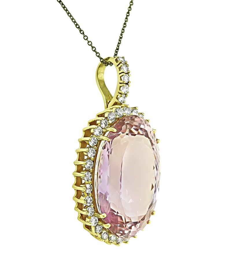 This is a charming 14k yellow gold pendant. The pendant is centered with a lovely oval cut kunzite that weighs approximately 45.00ct. The center stone is accentuated by sparkling round cut diamonds that weigh approximately 2.00ct. The color of these