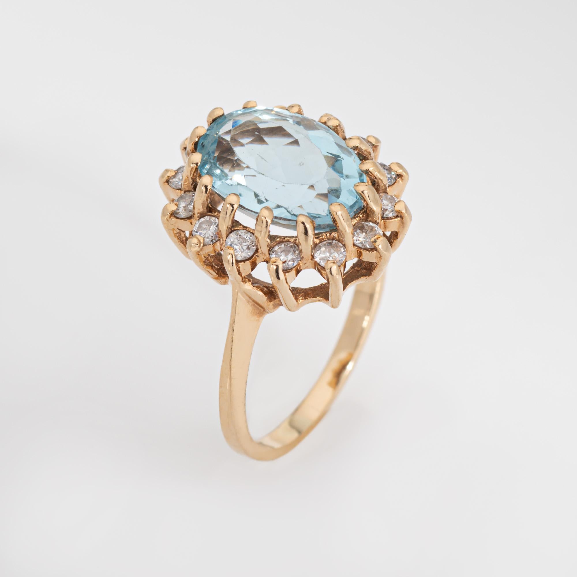 Stylish vintage aquamarine & diamond cocktail ring crafted in 14 karat yellow gold (circa 1980s). 

Oval faceted aquamarine measures 12mm x 8mm (estimated at 4.50 carats). 14 round brilliant cut diamonds total 0.28 carats (estimated at I-J color and