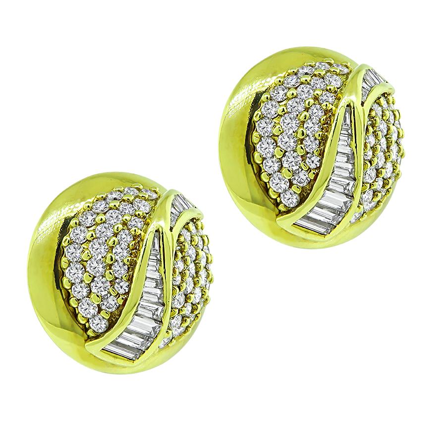 This is an elegant pair of 18k yellow gold earrings. The earrings feature sparkling round and baguette cut diamonds that weigh approximately 4.50ct. The color of these diamonds is E-F with VS clarity. The earrings measure 22mm in diameter and weigh