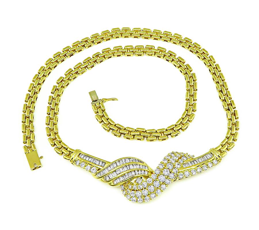 This is a gorgeous 18k yellow gold necklace. The necklace is set with sparkling baguette and round cut diamonds that weigh approximately 4.50ct. The color of these diamonds is F-G with VS clarity. The necklace measure 16 1/2 inches in length and