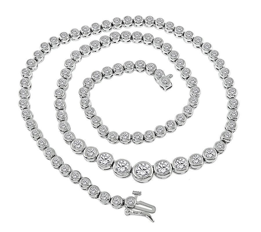 This is a gorgeous 14k white gold necklace. The necklace is set with sparkling round cut diamonds that weigh approximately 4.50ct. The color of these diamonds is H-I with VS2-SI1 clarity. The necklace has a tapering width from 4mm to 6.5mm. The