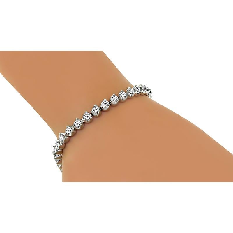 This is a fabulous 10k white gold tennis bracelet. The bracelet is set with sparkling round cut diamonds that weigh approximately 4.50ct. The color of these diamonds is I with SI2 clarity. The bracelet measures 6 3/4 inches in length and 4.5mm in