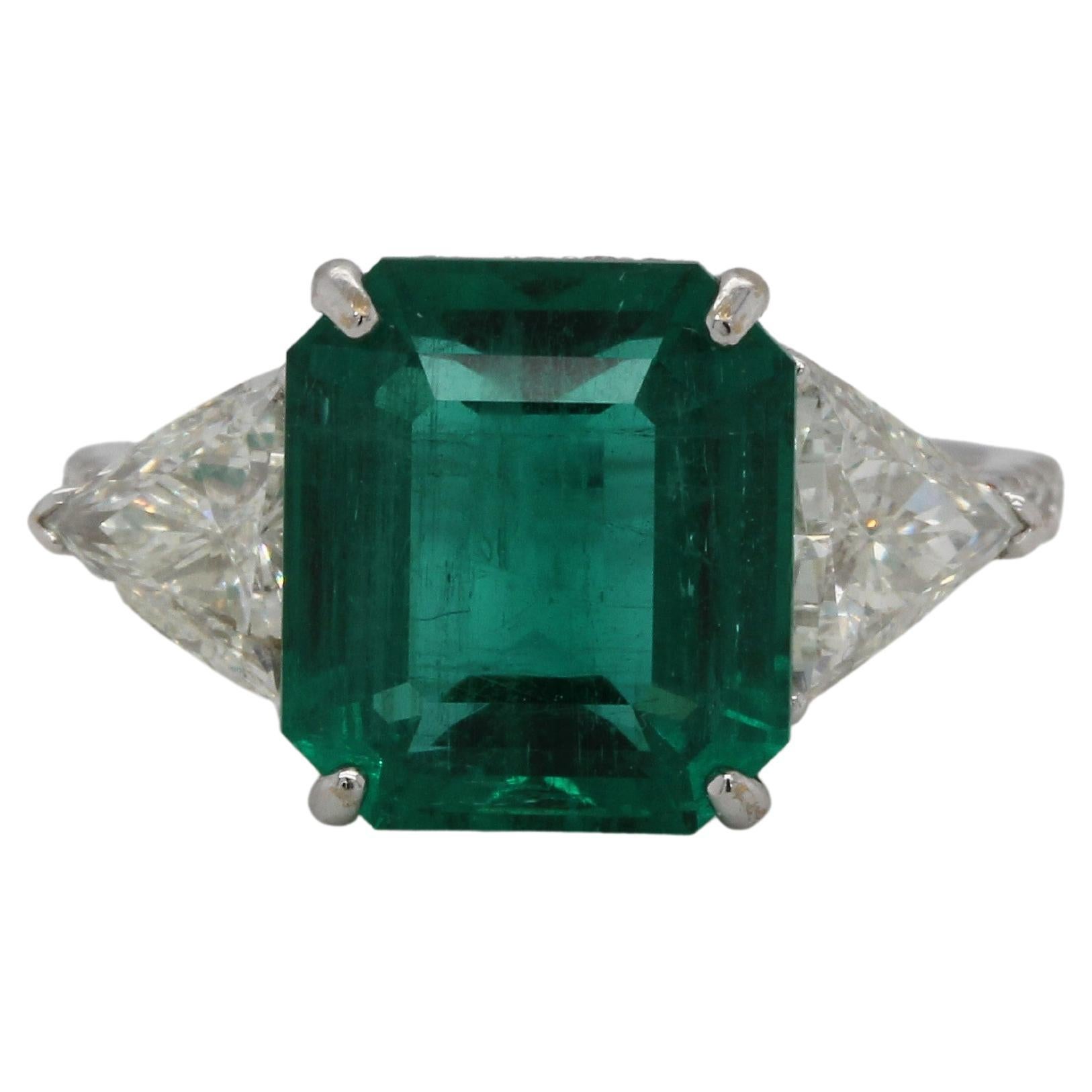 This timeless emerald and diamond ring is a chic statement piece to be enjoyed for years to come. Set in 18K white gold and layered with 0.42 carat of round diamonds, this elegant ring features an emerald cut 4.51 carats natural emerald that is