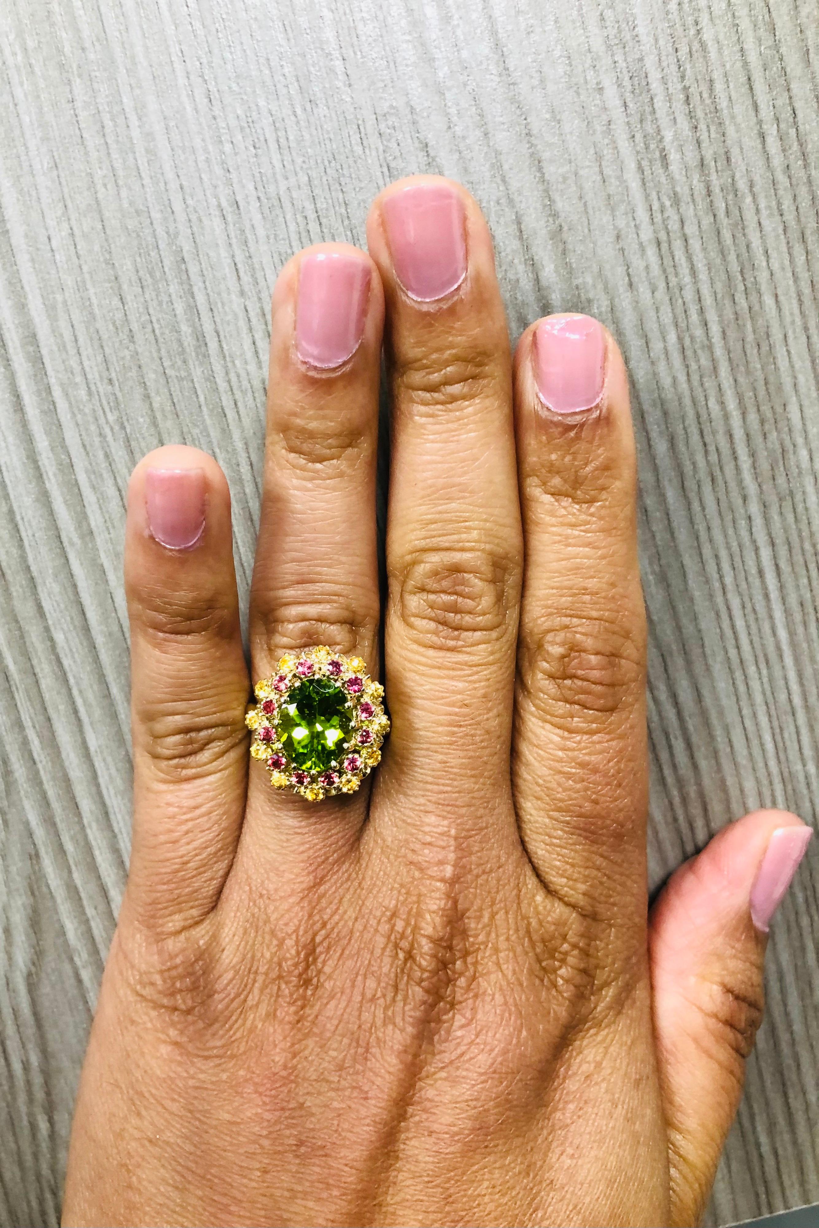 Oval Cut 4.51 Carat Peridot Yellow and Red Sapphire 14 Karat Yellow Gold Cocktail Ring For Sale