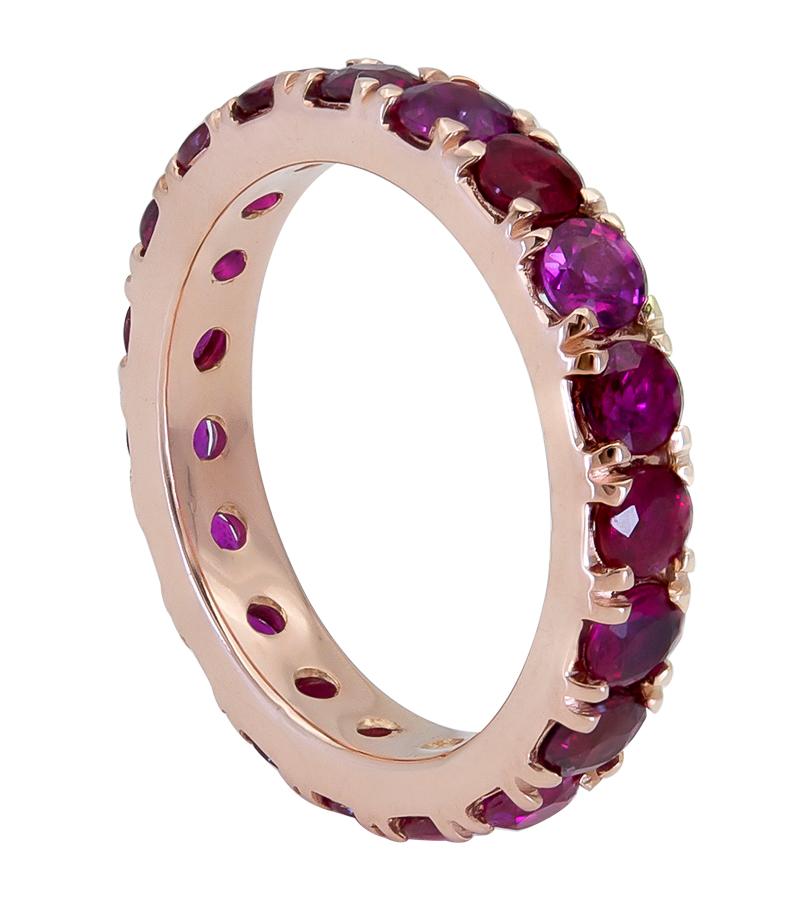 A color-rich and unusual wedding band showcasing a row of rubies set in a polished 18k rose gold mounting.
Rubies weigh 4.51 carats total. Can be used as a right hand or fashion ring as well.
Size 6.5 US. 

Style is available for any size finger.