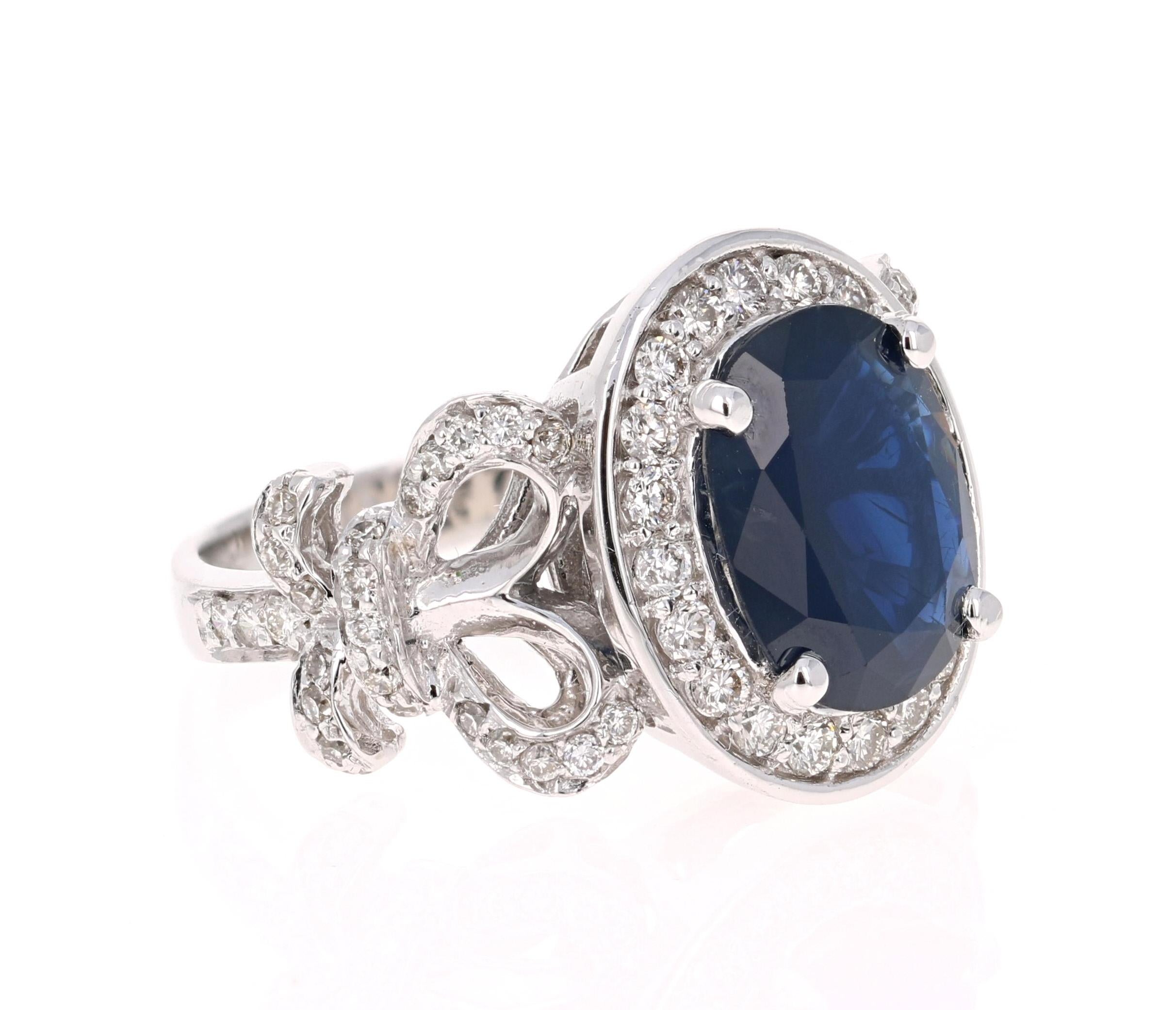 This dark blue sapphire ring has a Oval Cut 3.59 Carat Blue Sapphire and is surrounded by 68 Round Cut Diamonds that weigh 0.94 Carats. The diamonds are VS-H in clarity and color. The total carat weight of the ring is 4.53 Carats. The Sapphire is a