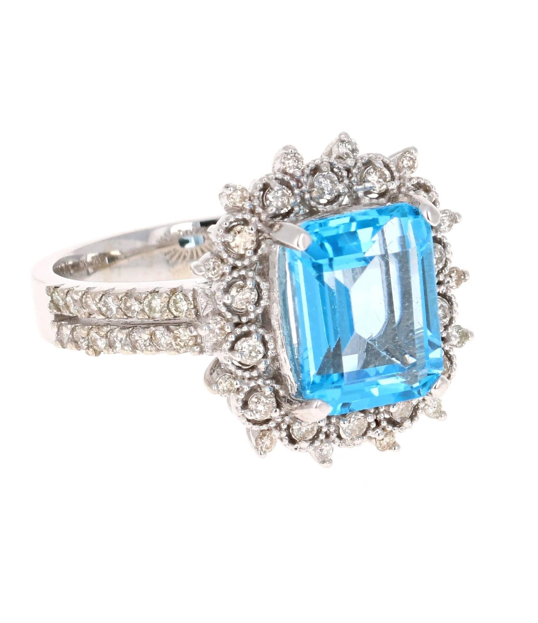 This beautiful Emerald cut Blue Topaz and Diamond ring has a stunning 4.07 Carat Blue Topaz and its surrounded by 56 Round Cut Diamonds that weigh 0.46 Carats. The total carat weight of the ring is 4.53 Carats. 
The setting is crafted in 14K White