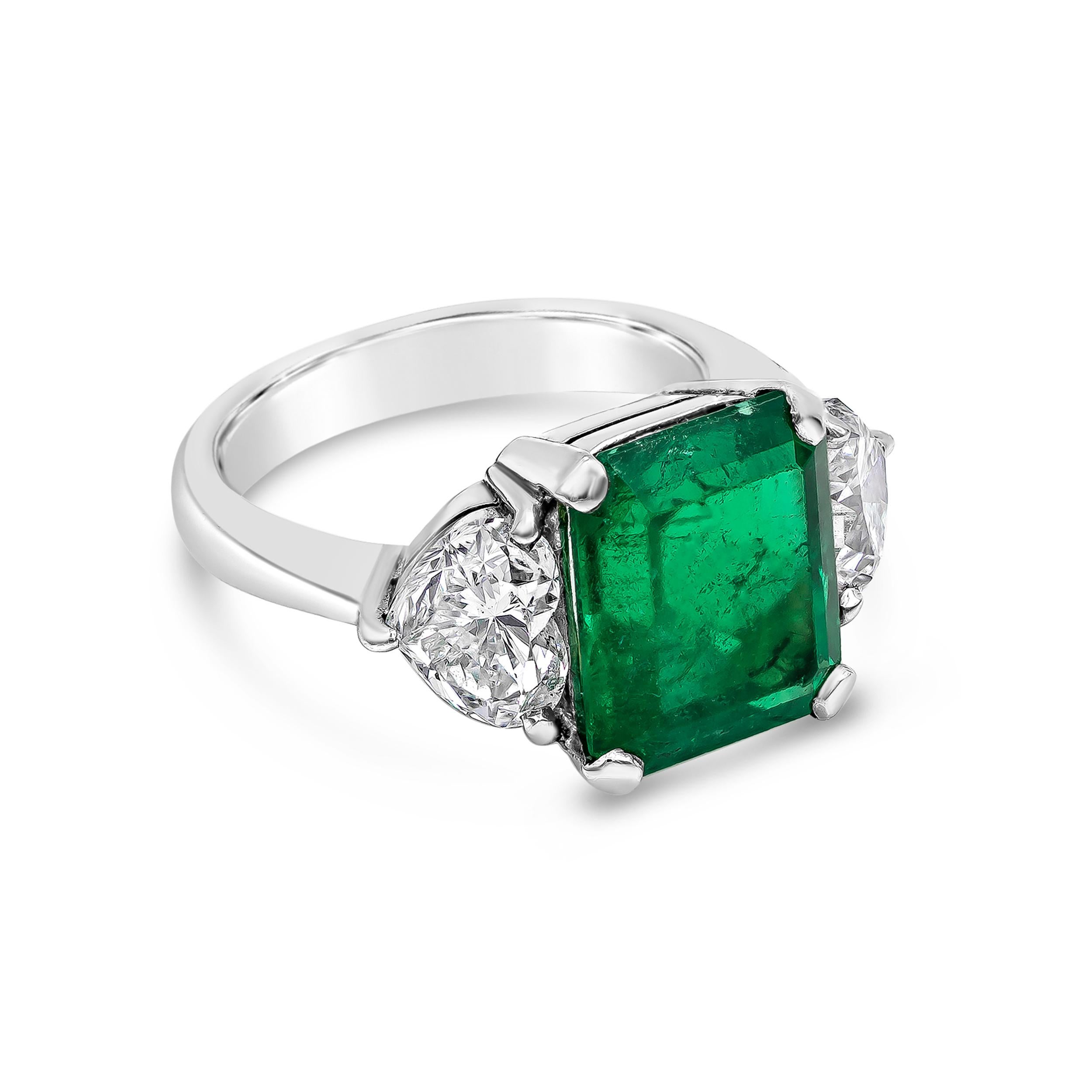 A chic engagement ring showcasing a 4.53 carat emerald cut green emerald, flanked by two heart shape diamonds weighing 2.01 carats total. Each diamond is certified by GIA as E-F color, SI1 clarity. Made in platinum.

Style available in different