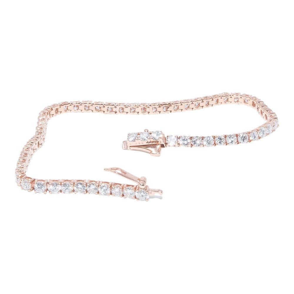 14k rose gold bracelet containing 4.54 carats of prong set diamonds. The color and clarity grades of the diamonds contained within the bracelet are E-F, VS1-SI1, respectively. The average polish, symmetry, and cut grade for each of these diamonds is