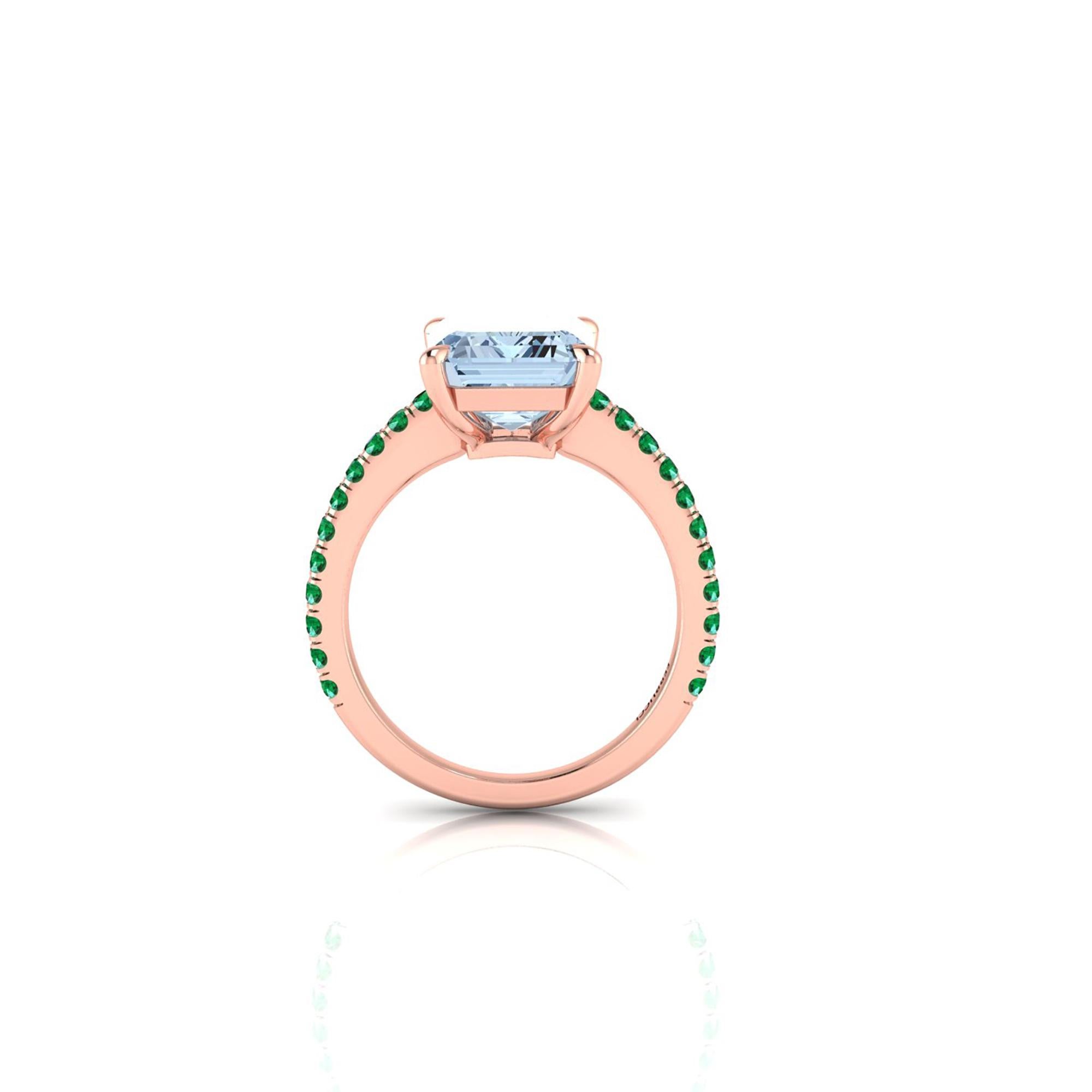 An exquisite 4.54 carat Aquamarine, emerald cut, very high quality color, eye clean gem, accompanied a pave' of bright green Emeralds of approximately  total carat weight of 0.35 carat, set in an hand crafted, delicate and sophisticated looking 18k