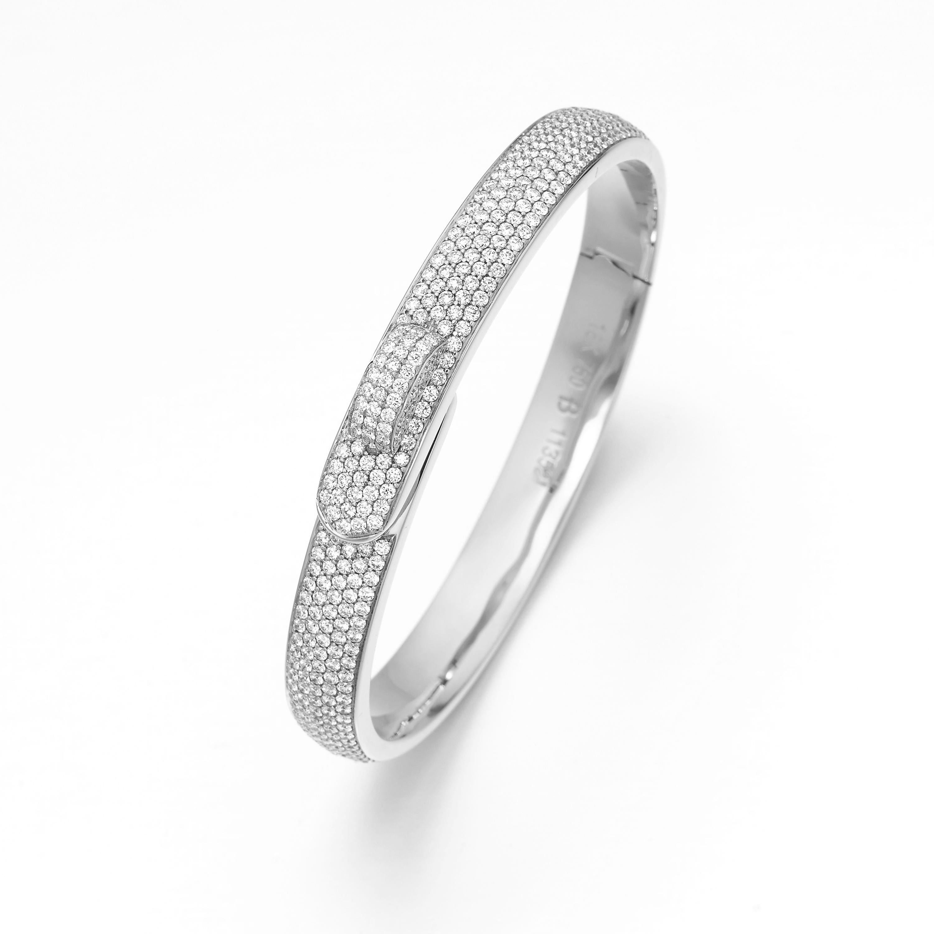 Butani's bangle features a subtle belt fastening design.  Embellished with 4.54 carats of pavé round diamonds, the bracelet is handcrafted in 18 karat white gold.  Perfect for stacking.  Wear yours as an everyday signature.  

Composition: 
18K