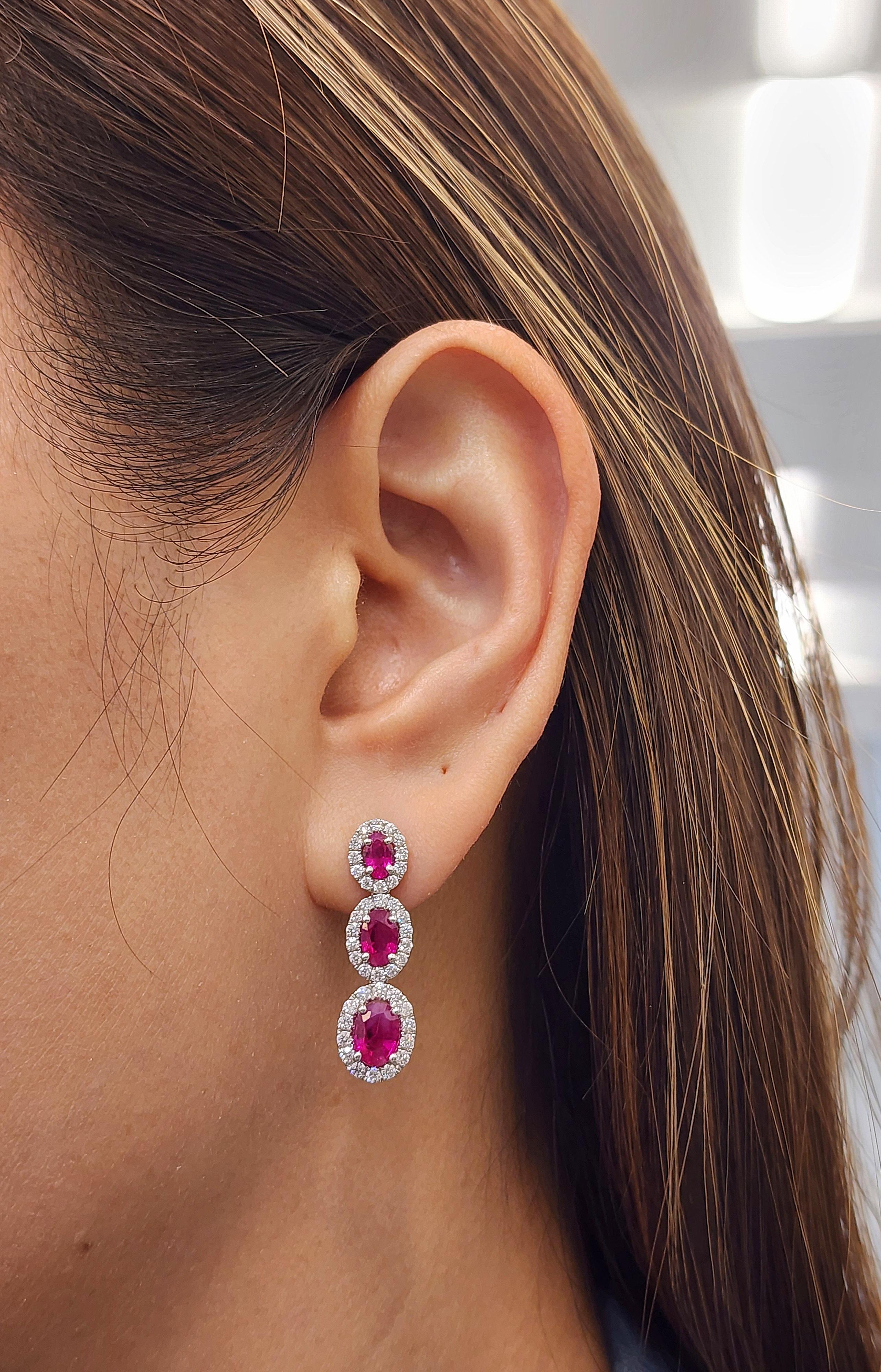 These gorgeous 4.54 total carat natural Burma ruby and diamond earrings are a show-stopper. The earrings feature 6 rubies with a total weight of 3.31, and 80 round diamonds surrounding the rubies that boast a color of E/F, and VS1/VS2 in clarity. A