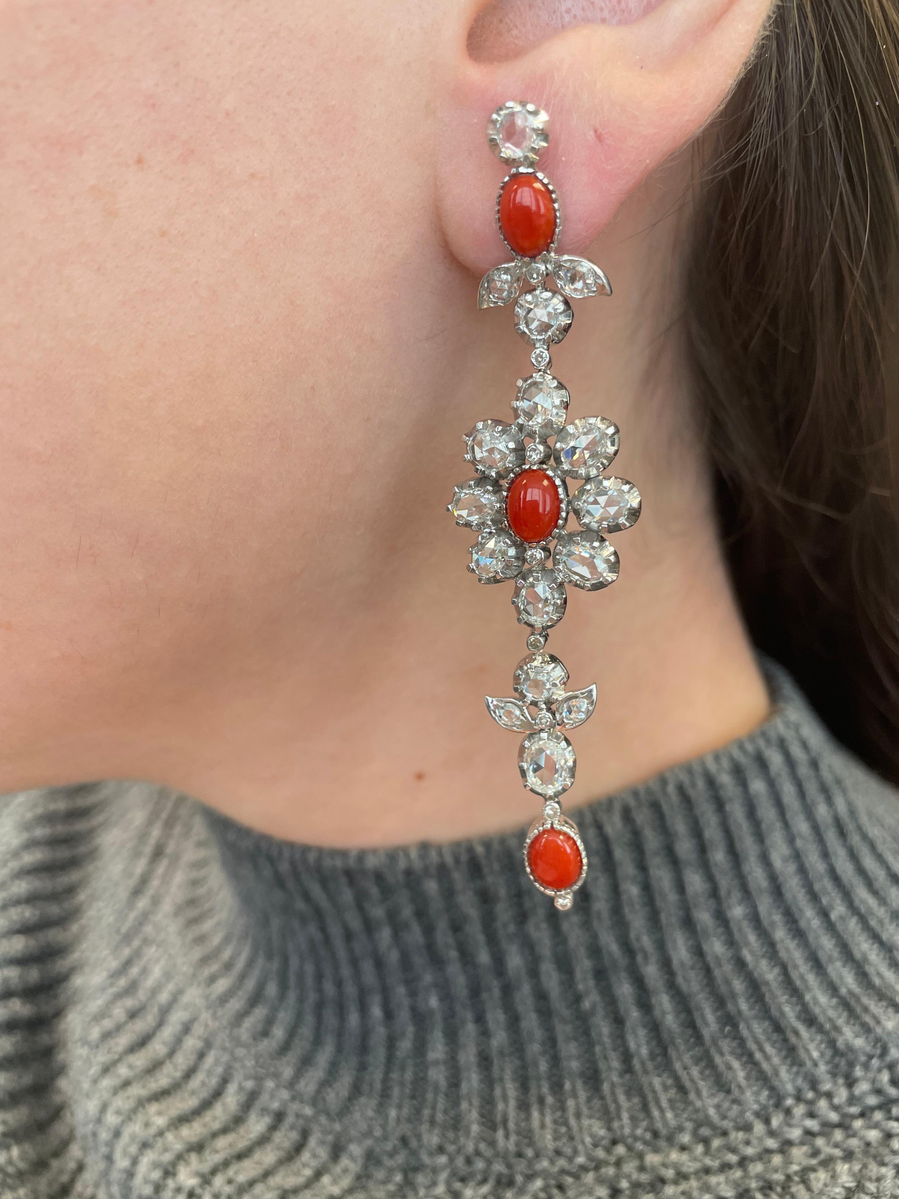 Gorgeous rose cut diamond and coral earrings with a vintage like look. 
4.54 carats of rose cut diamonds, approximately G/H color and VS2/SI1 clarity. Complimented with 6 cabochon coral, 18-karat white gold.
Accommodated with an up to date appraisal