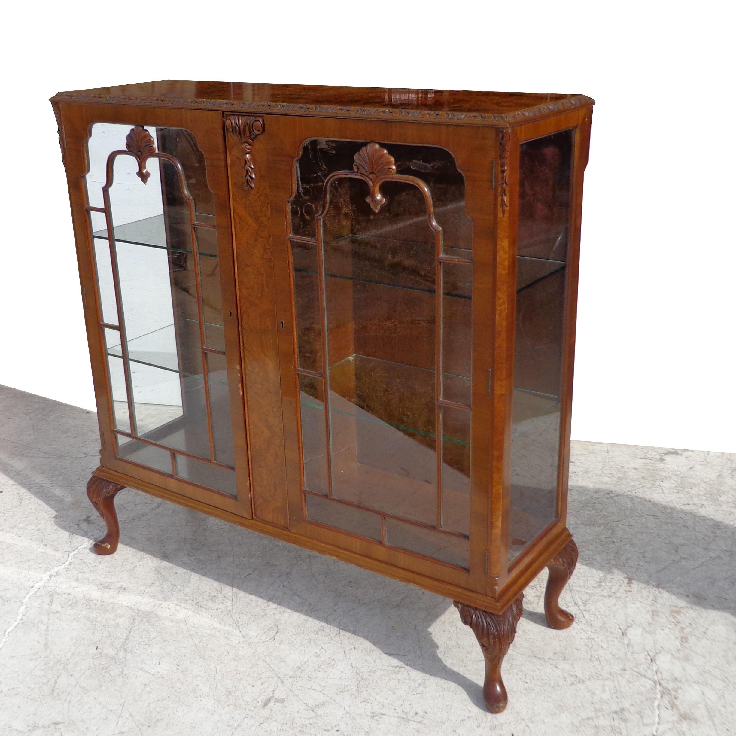 Art Deco Display Curio cabinet
Pratts of Bradford

Beautiful burled walnut with double doors opening to 2 glass shelves. Carved cabriole legs with decorative appliques on doors. Measure: 45.5