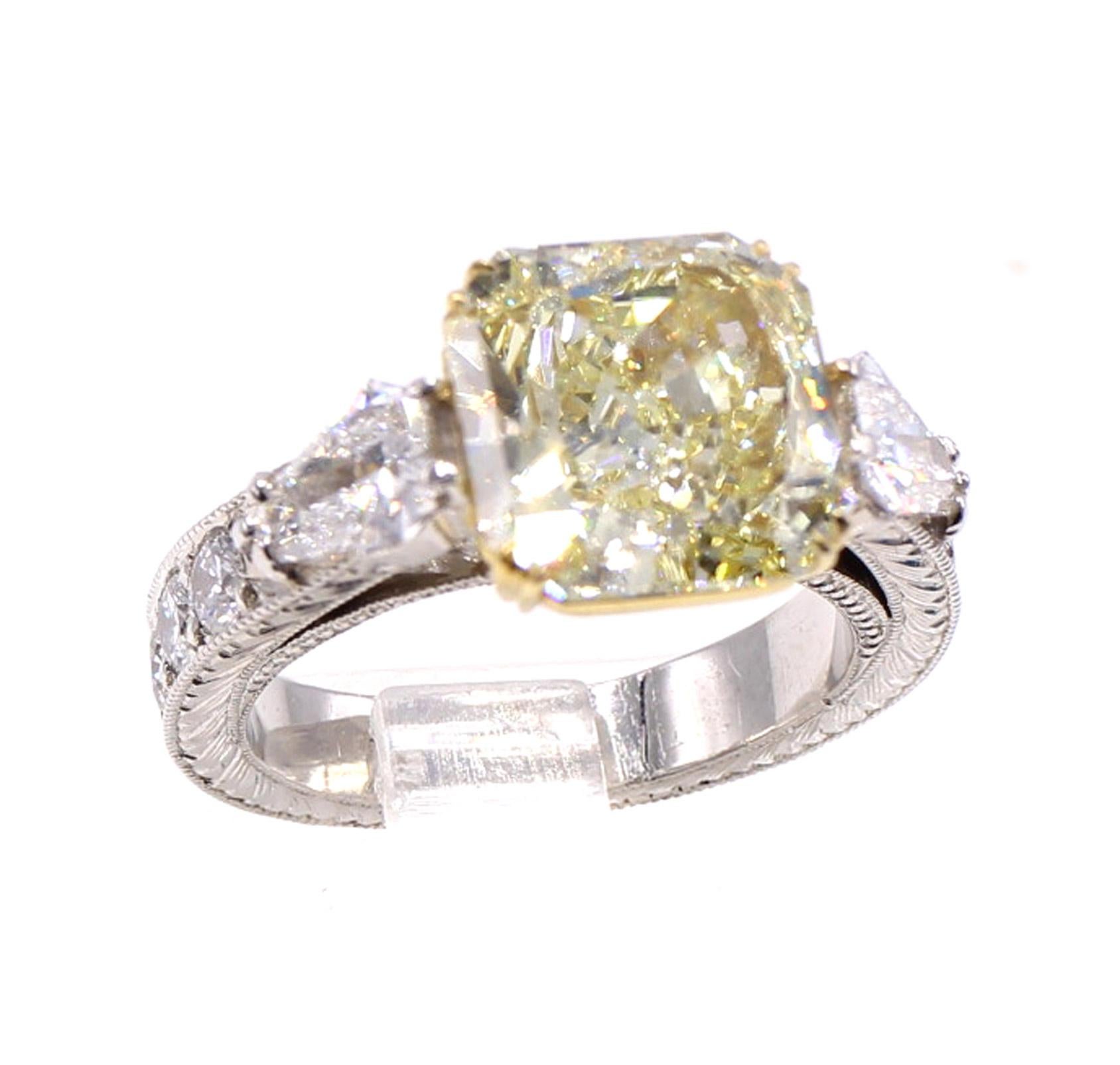The center piece of this beautifully designed and wonderfully handcrafted engagement ring is a lovely lemon colored Natural Fancy Yellow diamond weighing 4.55 carats. With a depth percentage of 56.5 and a diameter of 9.84 by 9.78 millimeters, this