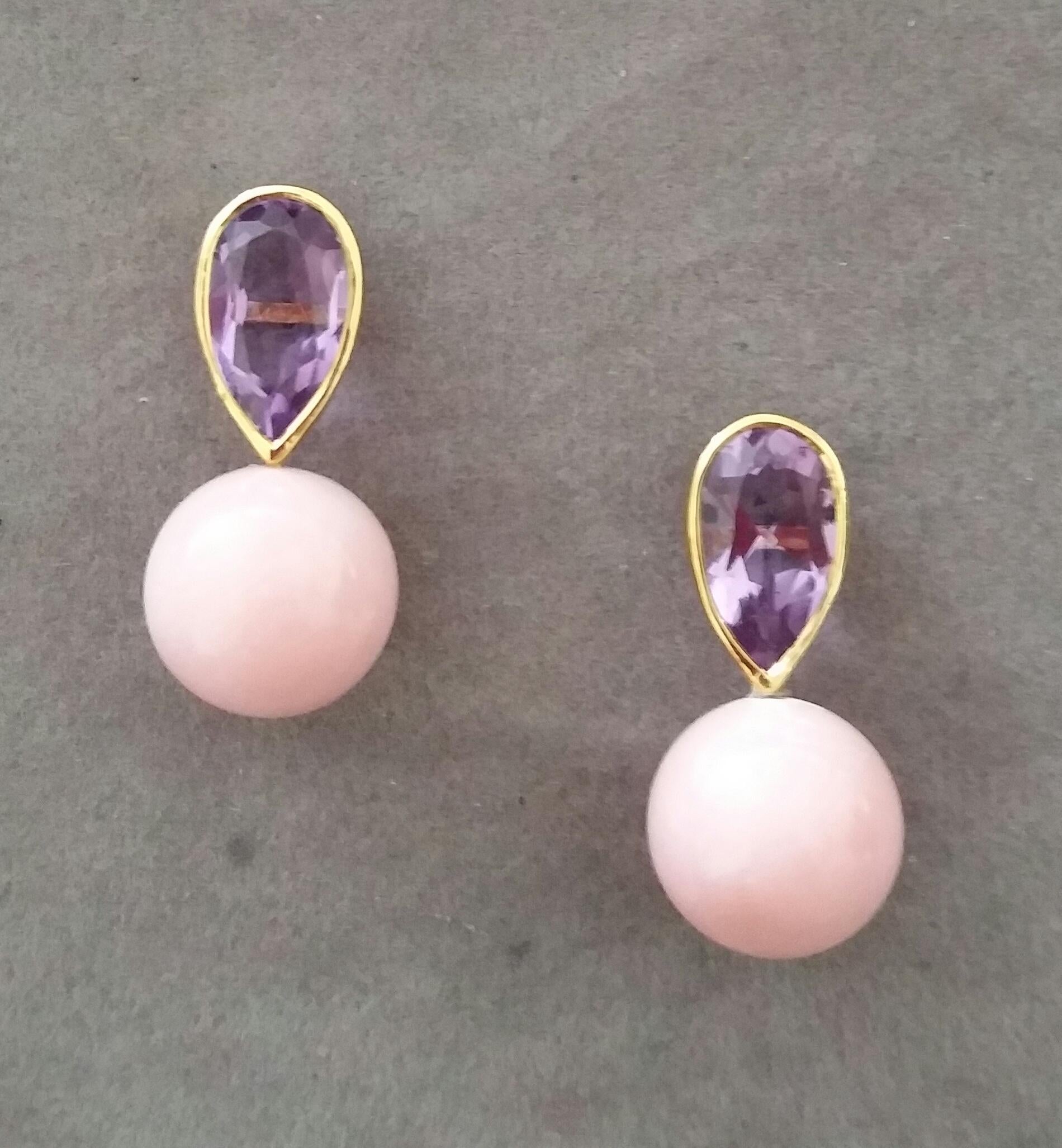 These simple but elegant handmade earrings have 2 faceted Natural Pear Shape Amethysts measuring 7 x 12 mm and weighing 4,55 carats set in yellow gold bezel at the top to which are suspended 2 Pink Opal Plain Round Beads measuring 12 mm in