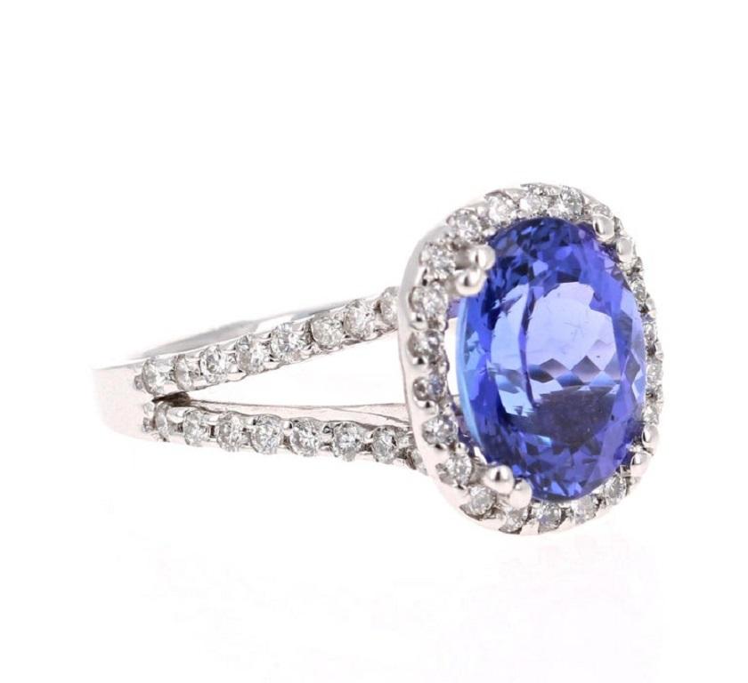 This beautiful ring has a vivid 3.82 Carat Oval Cut Tanzanite. The Tanzanite is surrounded by 54 Round Cut Diamonds that weigh 0.73 carats with a stunning split shank setting. (Clarity: SI, Color: F) The total carat weight of the ring is 4.55