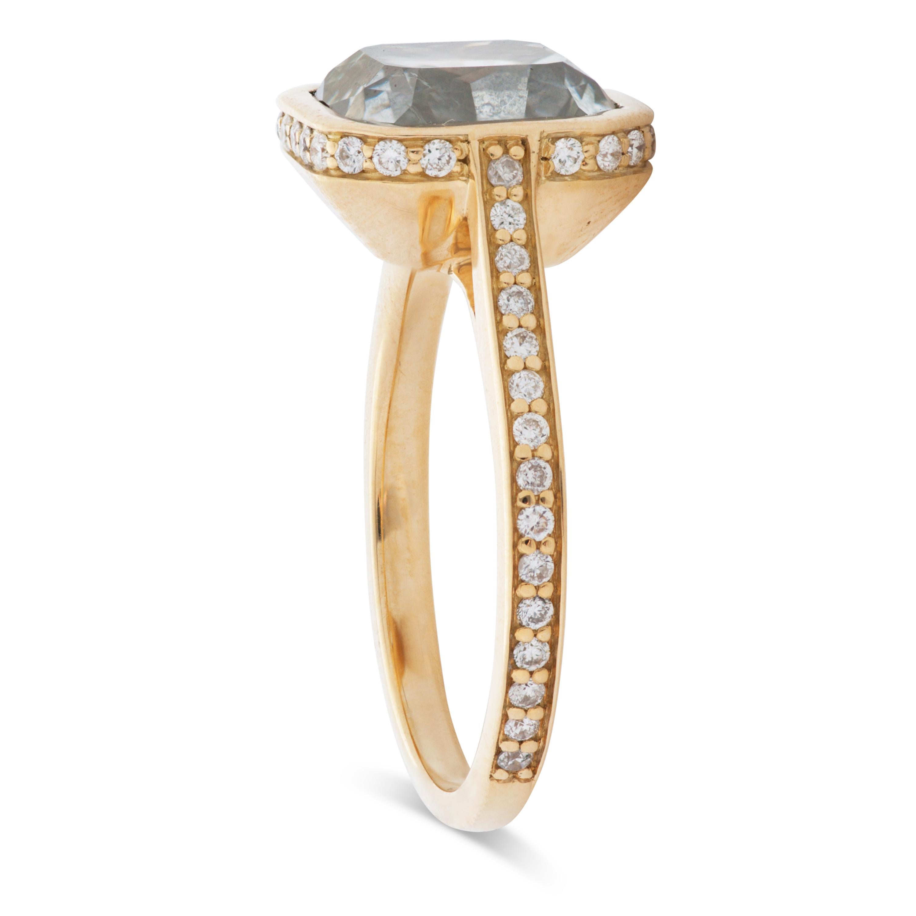 This modern engagement ring features a 4.55 carat very light gray radiant cut diamond with SI2 clarity bezel set in 18k yellow gold, accompanied by an IGI certificate.  52 round brilliant cut diamonds run around the bezel and down the shank totaling
