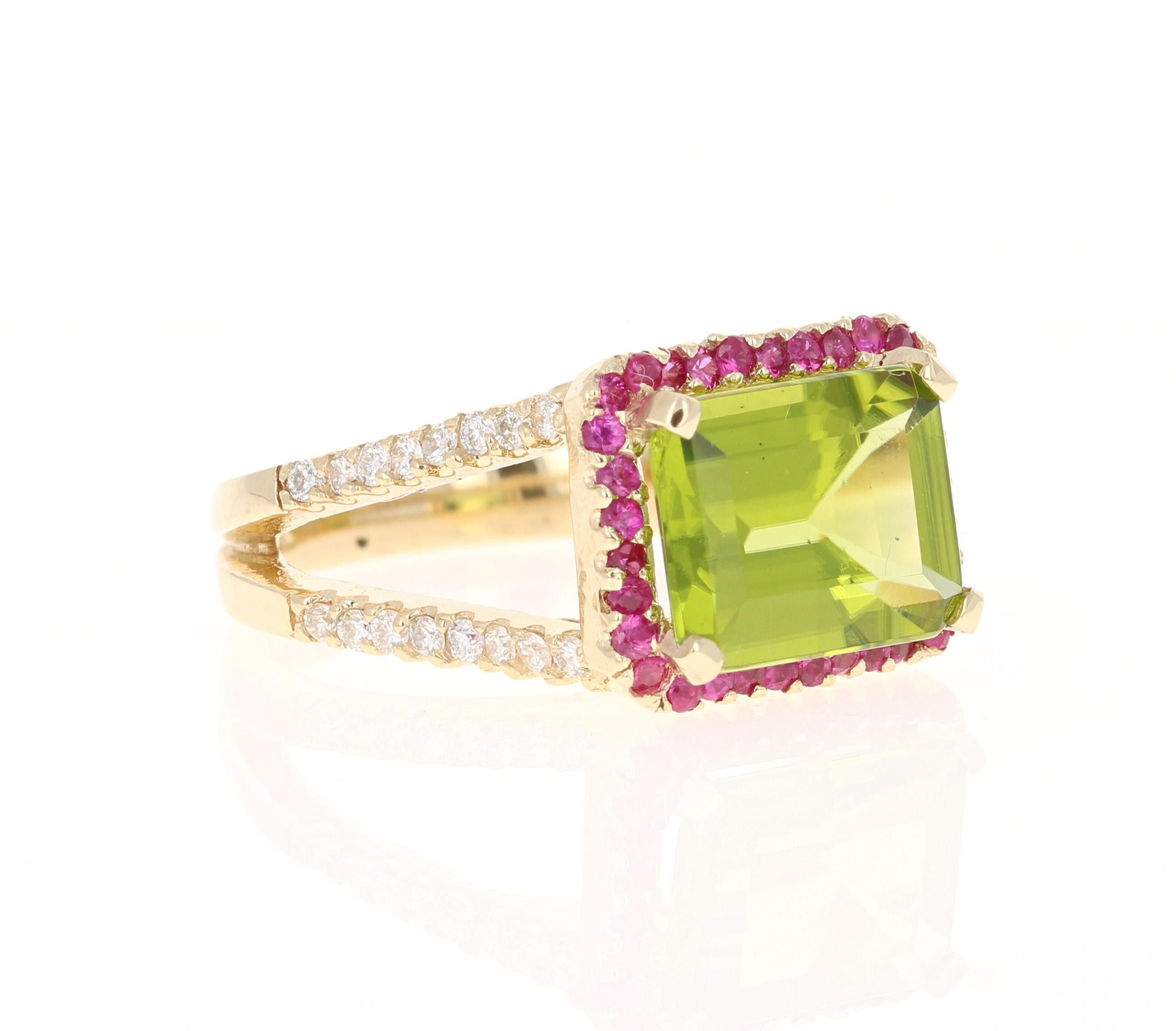 This beautiful ring has an Emerald Cut Peridot that weighs 4.10 Carats. The ring is surrounded by 32 Pink Sapphires that weigh 0.46 Carats and 42 Round Cut Diamonds that weigh 0.47 Carats. (Clarity: SI, Color: F)  The total carat weight of this ring