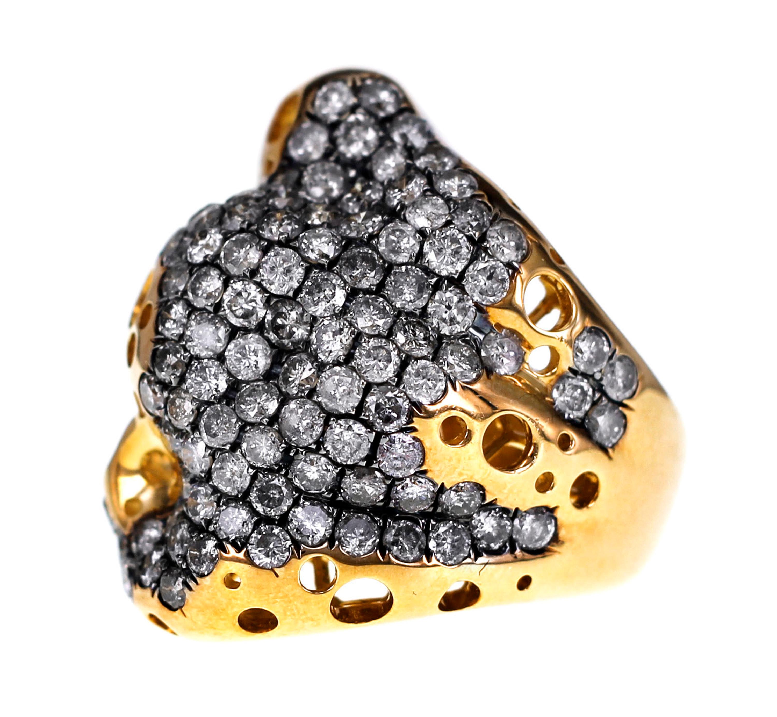 Made specially keeping in mind the recent trend of Gold heavy jewelry, the ring has been made with 'Malpani' vision. The gold heavy ring is set with 4.56 carat of natural fancy gray diamonds. The ring instantly catches your attention because of the