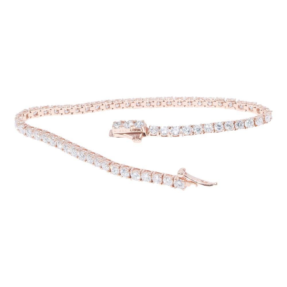 14k rose gold bracelet containing 4.57 carats of prong set diamonds. The color and clarity grades of the diamonds contained within the bracelet are E-F, VS1-SI1, respectively. The average polish, symmetry, and cut grade for each of these diamonds is