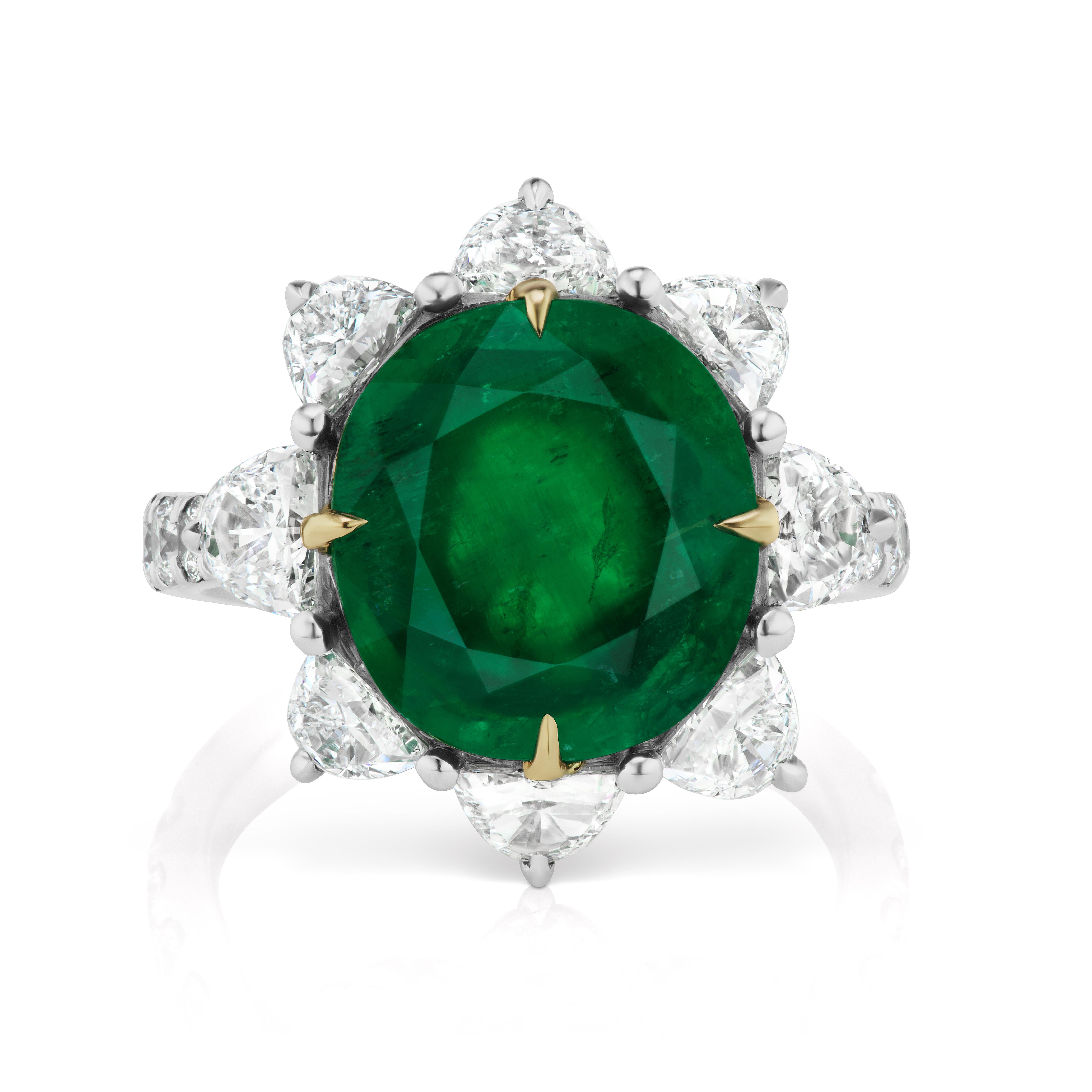 Centering upon a 4.57 Carat Cushion Cut Emerald surrounded by 8 Half Moon Diamonds weighing 1.57 Carats and 14 Round Brilliant Diamonds on the shank weighing 0.60 Carats. 
Set in Platinum and 18 Karat Yellow Gold.
Size 6.