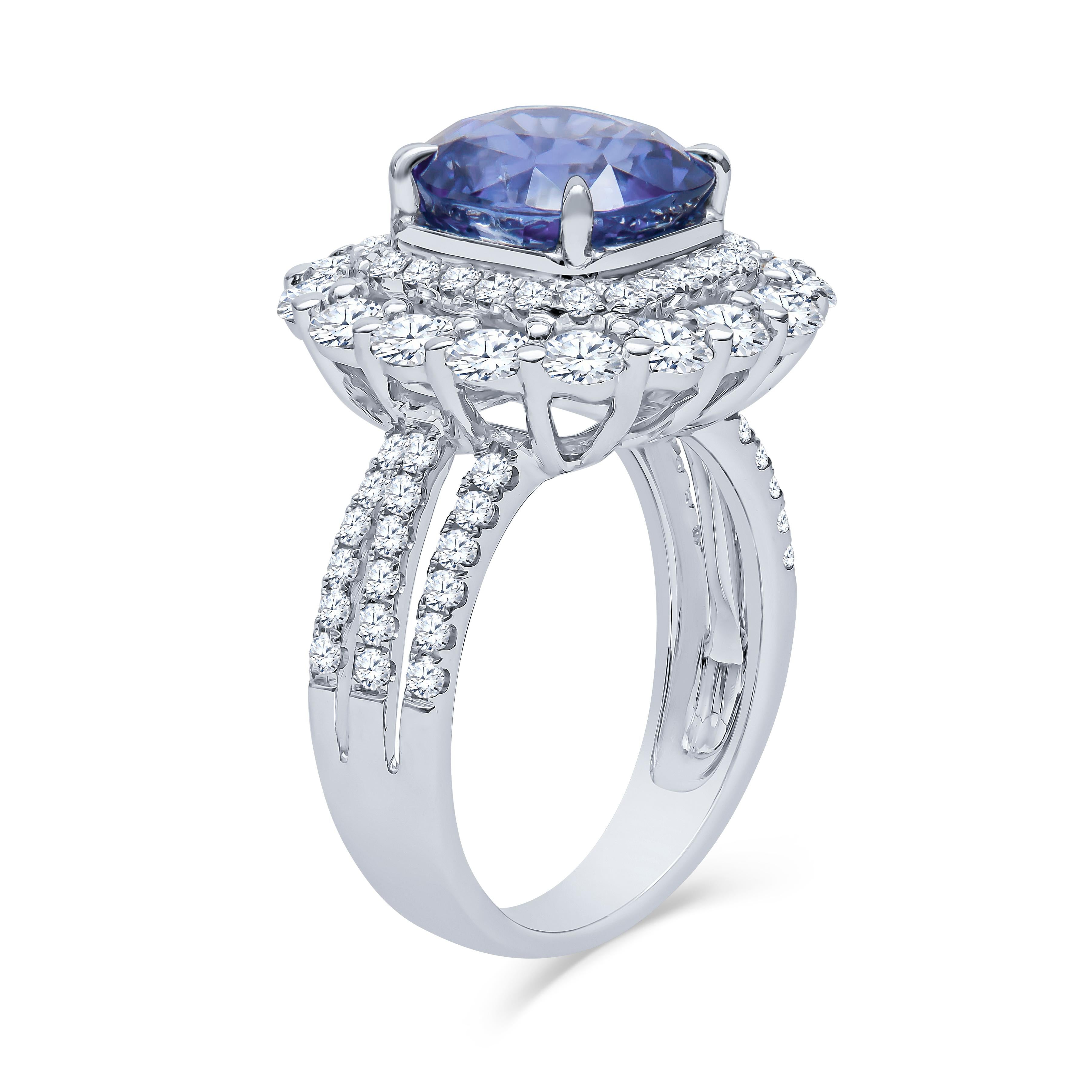 4.57 Carat total cushion cut Ceylon natural, heat only, blue sapphire (AGL report) with 1.93 carats total weight in round brilliant natural diamonds set in a double halo setting 18K white gold ring. This is a highly sought after 'cornflower' blue