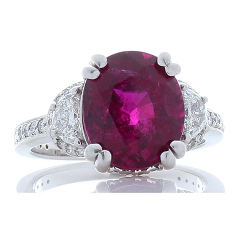 This ravishing vivid raspberry-hued gemstone ring is an incredible sight to behold! The ring features a dynamic 4.57 carat -  10.80 x 9.30 millimeter vivid rubellite that exhibits radiant pink, purple, red, and gorgeous light reflections. This gem