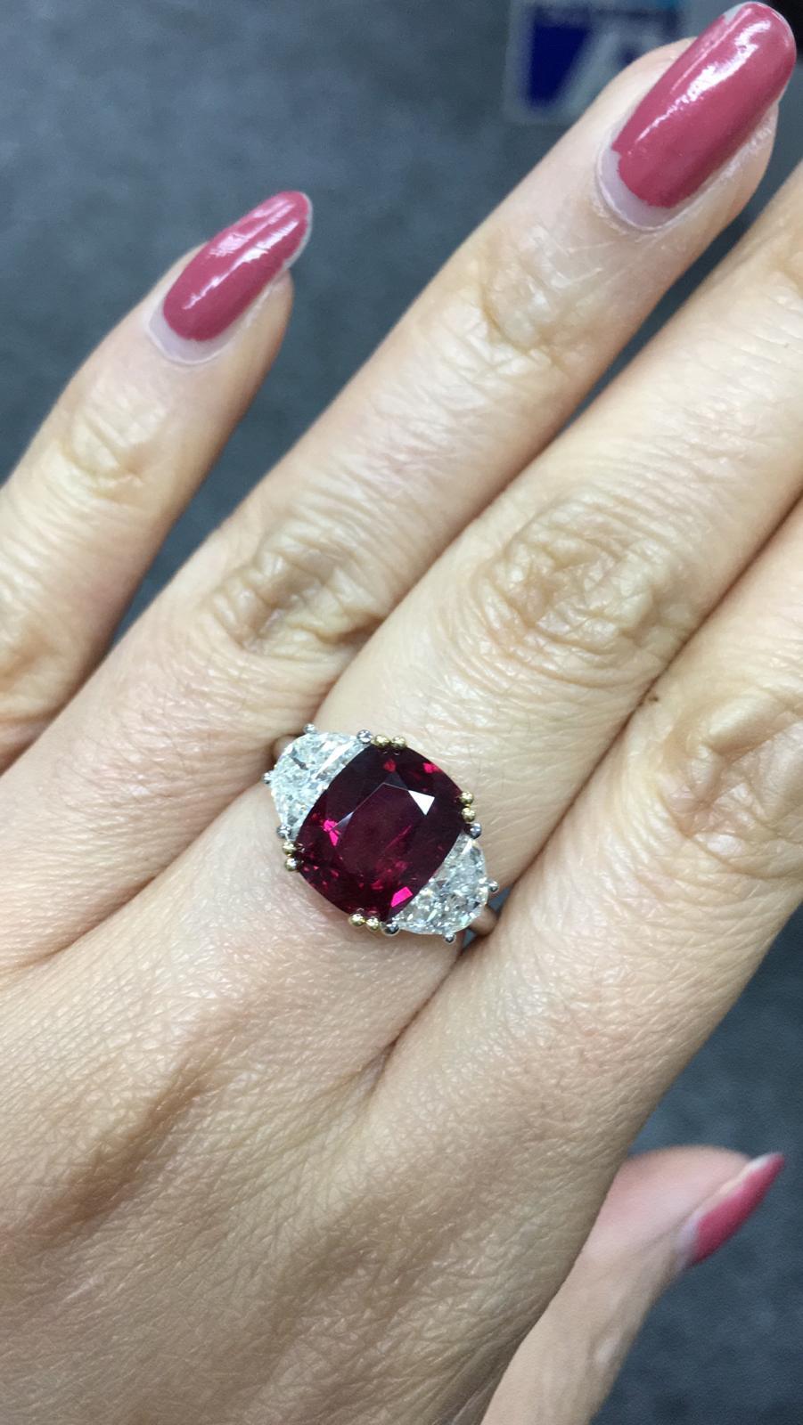 Primary Stone: Ruby (Madagascar) VIVID RED PIGEON BLOOD 
Shape : Cushion Cut
Ruby Weight: 4.58 Carats 
Measurements Ruby : 10.60mm x 8.44mm x 4.97mm
Color: Vivid Red Pigeon Blood 
Accent Stones: Genuine Diamond
Shape Or Cut Diamond: 2 Half Moon