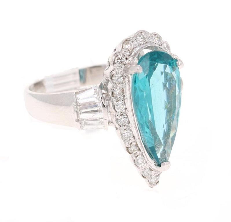 This ring has a Pear Cut Apatite that weighs 3.55 carats and measures at 15 mm x 9 mm. 
There are 22 Round Cut Natural White Diamonds that weigh 0.35 carats and 6 Baguette Cut Natural White Diamonds that weigh 0.68 carats. The total carat weight of