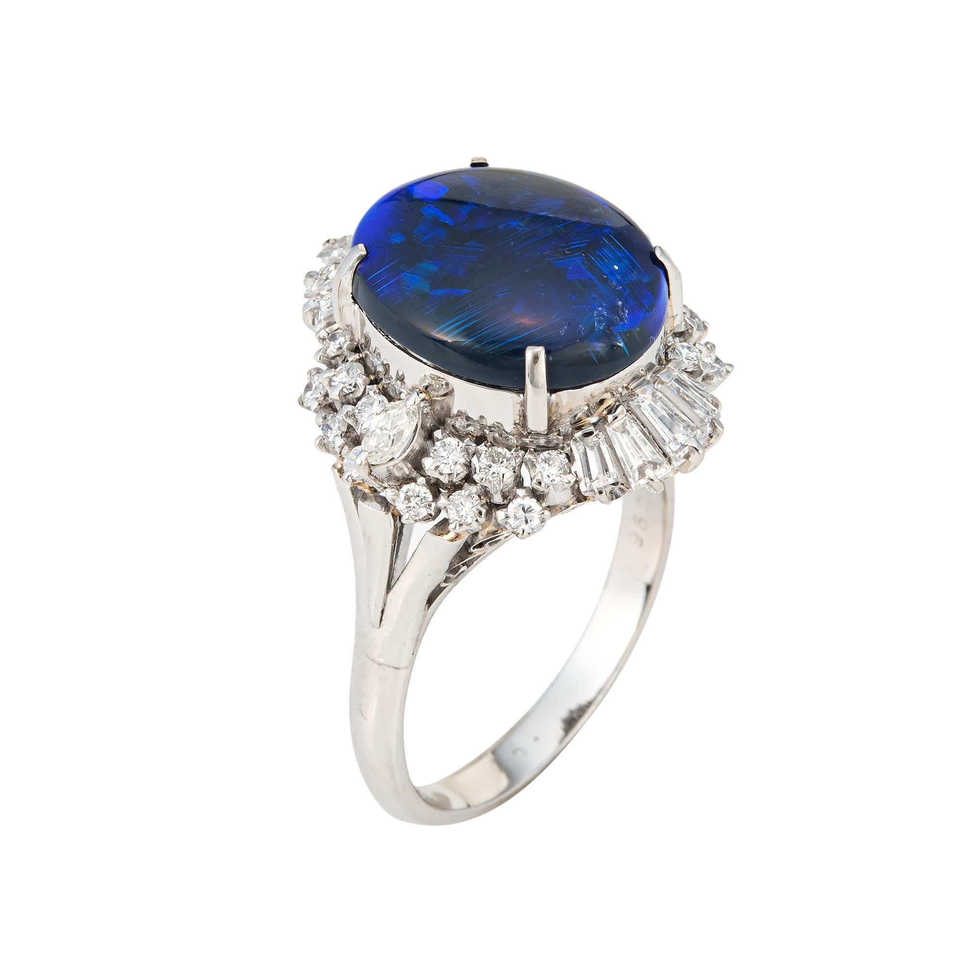 Stylish 4.58ct natural black opal & diamond cocktail ring crafted in platinum. 

Cabochon cut oval shaped natural black opal measures 14mm x 11.5mm (4.58 carats). Mixed cut diamonds (marquise, baguette & round brilliant cuts) total an estimated 0.96