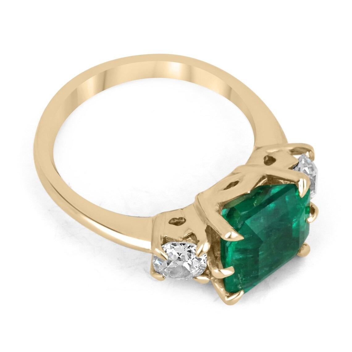 A victorian inspired Colombian emerald and old European cut diamond three-stone ring. Dexterously crafted in gleaming 18K gold this ring features a rare, 3.68-carat natural Colombian emerald-Asscher cut from the famous Muzo mines. Set in a bespoke