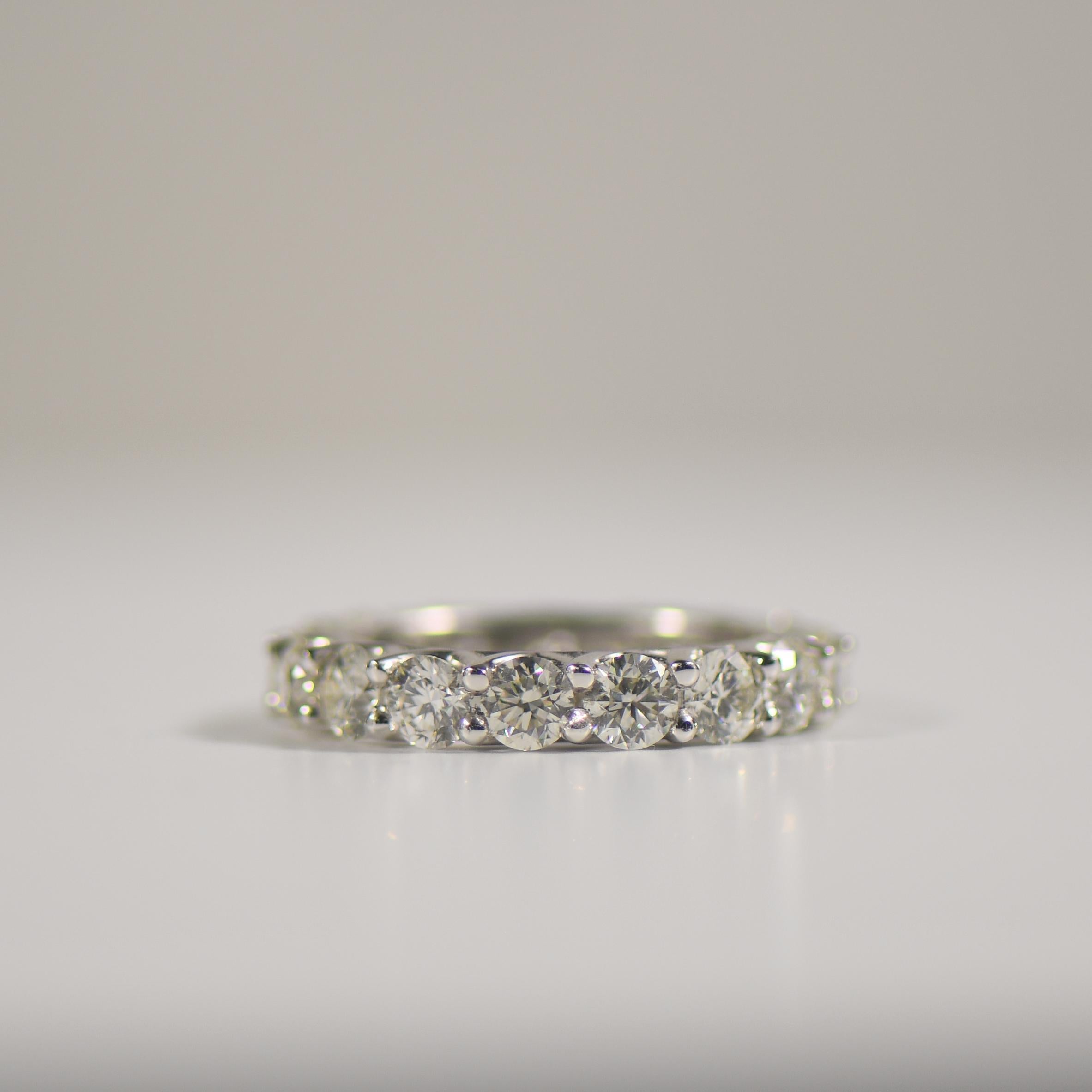 Elevate your style with our enchanting Eternity Diamond Band, a symbol of eternal love and sophistication. Set in lustrous 18k white gold, this timeless piece boasts approximately 4.50 carats total weight of dazzling diamonds, each meticulously